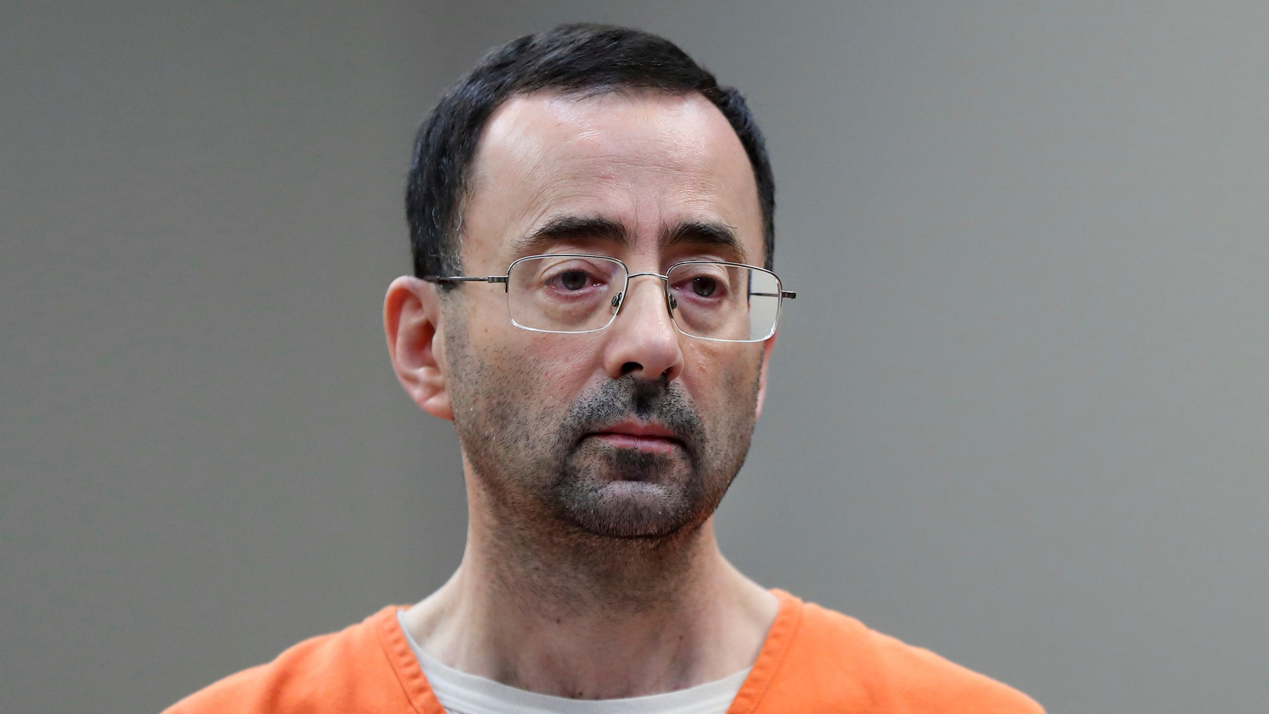 FILE - Disgraced former sports doctor Larry Nassar appears in court for a plea hearing, Nov. 22, 2017, in Lansing, Mich. Nassar was stabbed Sunday, July 9, 2023, in his cell at a federal penitentiary in Florida, out of view of surveillance cameras pointed at common areas and corridors. It’s the second time the ex-U.S. women’s gymnastics team doctor has been assaulted in federal custody while serving decades in prison for sexually abusing athletes. (AP Photo/Paul Sancya, File)