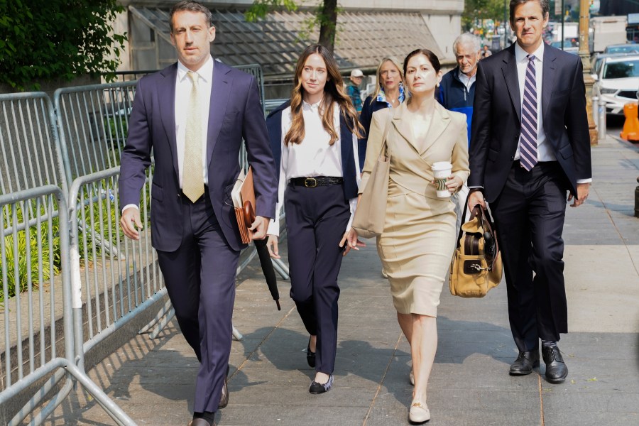 FILE - Charlie Javice, second from left, founder of a student loan assistance startup company charged with fraud, arrives at federal court with her legal team, June 6, 2023, in New York. Frank shook her head repeatedly Thursday, July 13, as a prosecutor claimed that she snookered J.P. Morgan Chase into paying $175 million for her business by lying about its client base. (AP Photo/Bebeto Matthews, File)