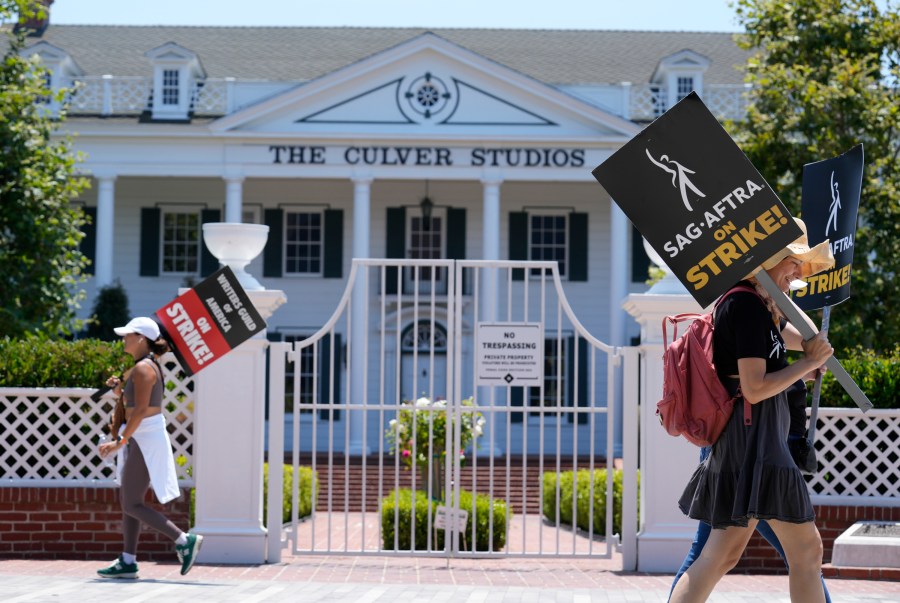 Picketers carry signs outside Amazon Studios in Culver City, Calif. on Monday, July 17, 2023. The actors strike comes more than two months after screenwriters began striking in their bid to get better pay and working conditions and have clear guidelines around the use of AI in film and television productions. (AP Photo/Chris Pizzello)