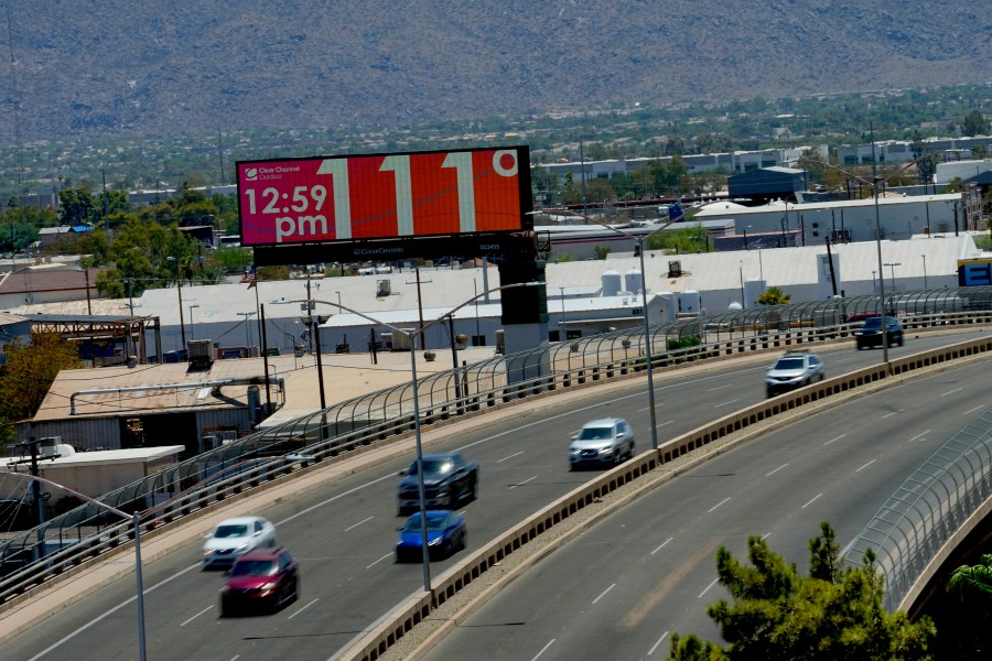 A digital billboard displays an unofficial temperature, Monday, July 17, 2023, in downtown Phoenix. (AP Photo/Matt York)