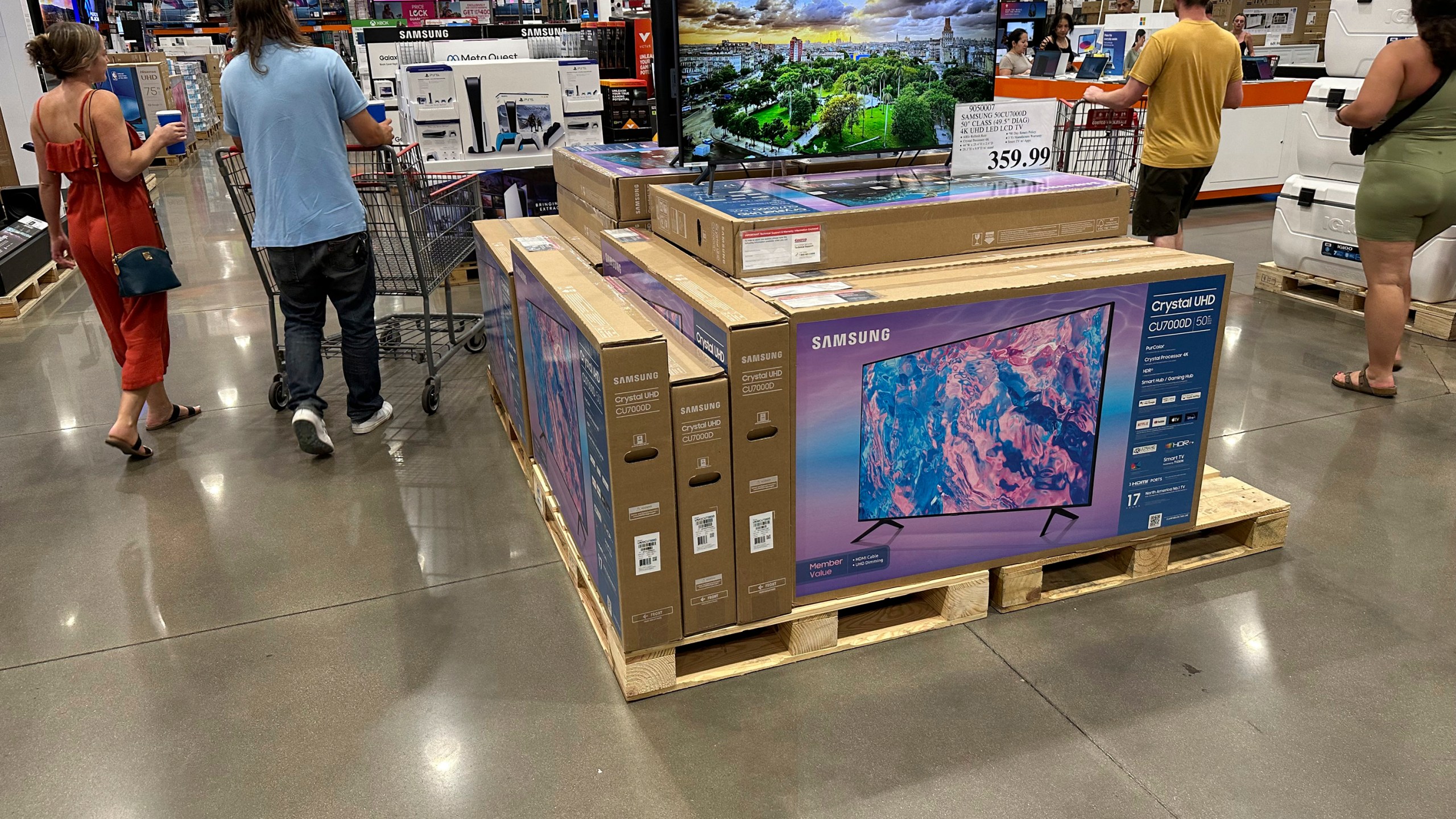 Shoppers glide past a display of big-screen televisions in a Costco warehouse on Tuesday, July 11, 2023, in Sheridan, Colo. On Tuesday, July 18, the Commerce Department releases U.S. retail sales data for June. (AP Photo/David Zalubowski)