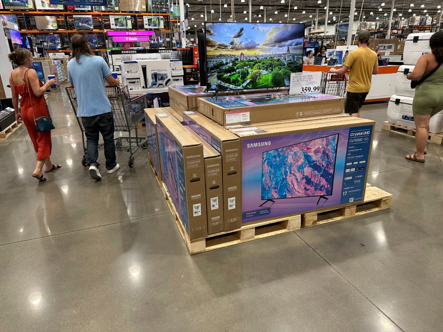 Shoppers glide past a display of big-screen televisions in a Costco warehouse on Tuesday, July 11, 2023, in Sheridan, Colo. On Tuesday, July 18, the Commerce Department releases U.S. retail sales data for June. (AP Photo/David Zalubowski)