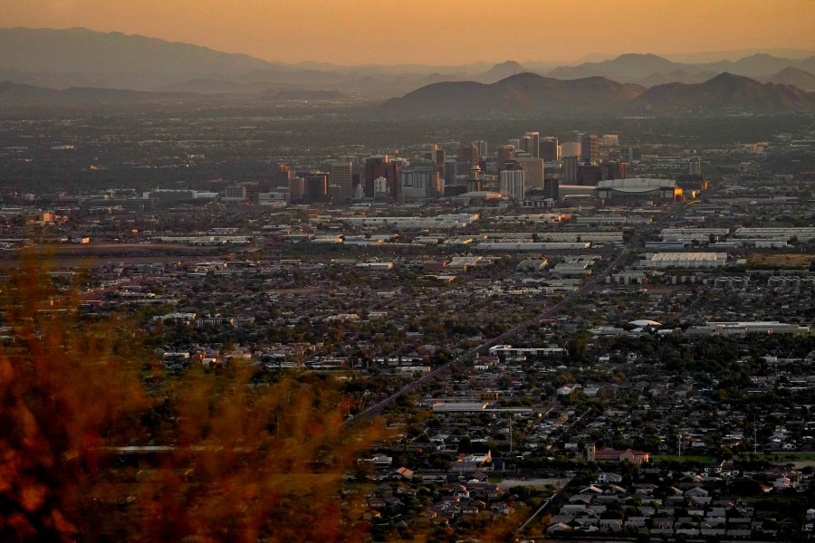 Day breaks over downtown Phoenix, Monday, July 17, 2023. Phoenix is set to break its own record for consecutive days of highs of at least 110 degrees. Around one-third of Americans are under some type of heat advisory, with the most blistering temperatures in the South and West, where even the regular simmer has turned up a notch. (AP Photo/Matt York)