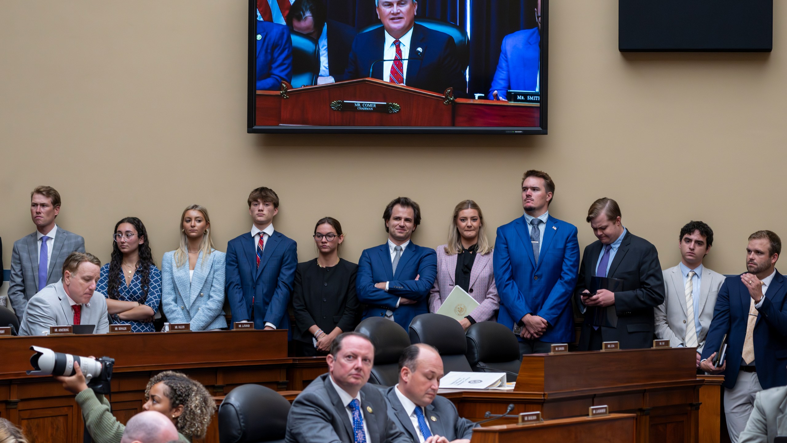 Congressional staffers stand beneath a monitor showing House Oversight and Accountability Committee Chair James Comer, R-Ky., as he charges that the Justice Department interfered with a yearslong investigation into Hunter Biden, during a hearing at the Capitol in Washington, Wednesday, July 19, 2023. (AP Photo/J. Scott Applewhite)