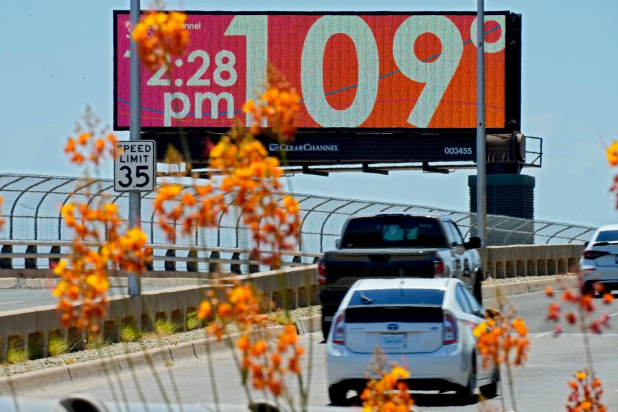 FILE - A digital billboard displays an unofficial temperature, Monday, July 17, 2023, in downtown Phoenix. In the past 30 days, nearly 5,000 heat and rainfall records have been broken or tied in the United States and more than 10,000 records set globally, according to the National Oceanic and Atmospheric Administration. Since 2000, the U.S. is setting about twice as many heat records as cold. (AP Photo/Matt York, File)