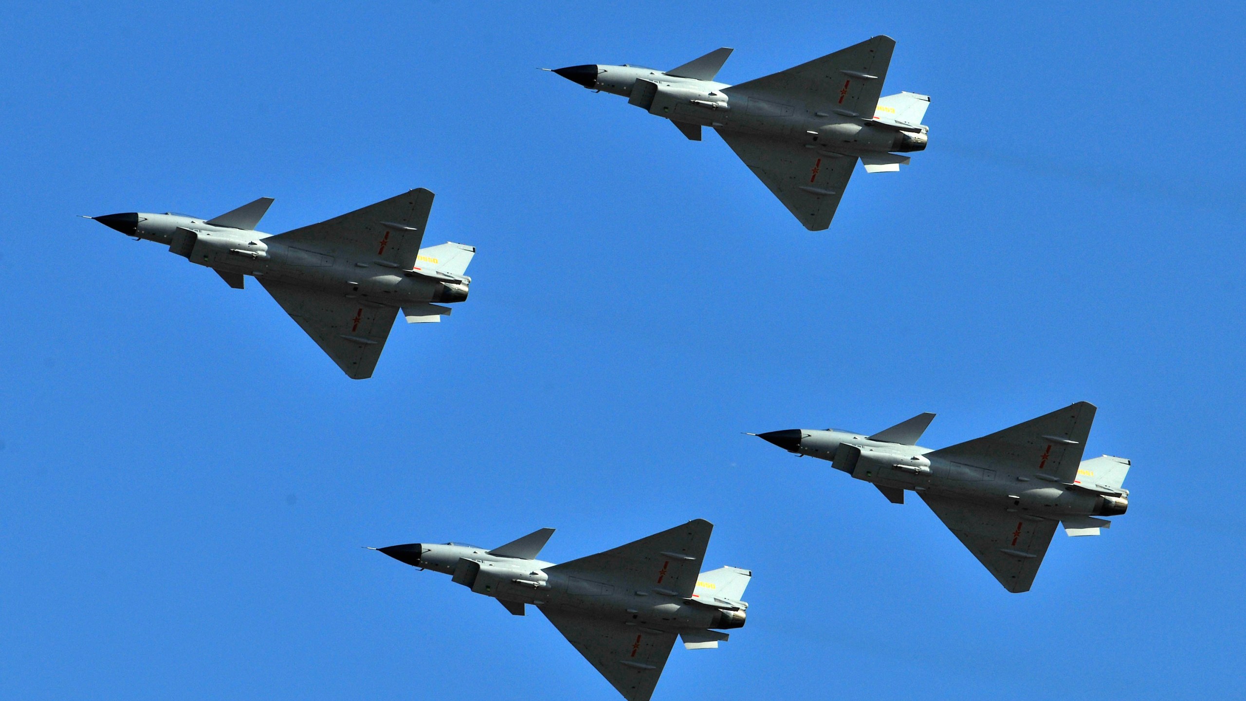 FILE - J-10 jet fighters perform in formation to celebrate the 60th anniversary of the People's Liberation Army Air Force in Beijing, China, Nov. 15, 2009. China sent dozens of warplanes, including fighter jets and bombers, toward Taiwan, the island's Defense Ministry said Saturday, July 22, 2023, marking a forceful display days before the democracy plans to hold military exercises aimed at defending itself against a possible invasion.(AP Photo/File)