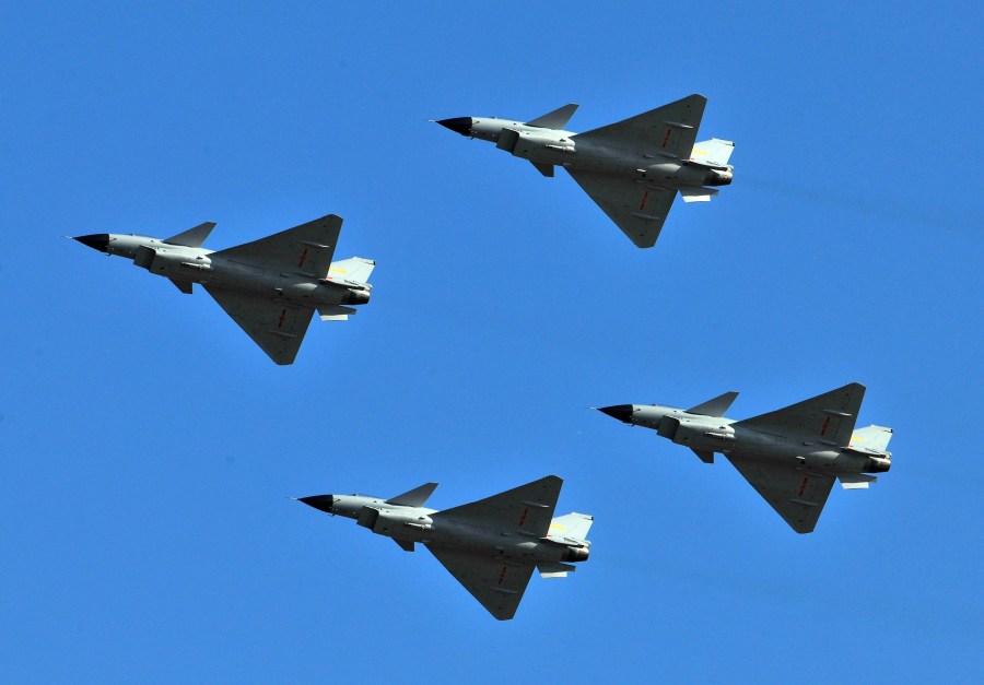 FILE - J-10 jet fighters perform in formation to celebrate the 60th anniversary of the People's Liberation Army Air Force in Beijing, China, Nov. 15, 2009. China sent dozens of warplanes, including fighter jets and bombers, toward Taiwan, the island's Defense Ministry said Saturday, July 22, 2023, marking a forceful display days before the democracy plans to hold military exercises aimed at defending itself against a possible invasion.(AP Photo/File)