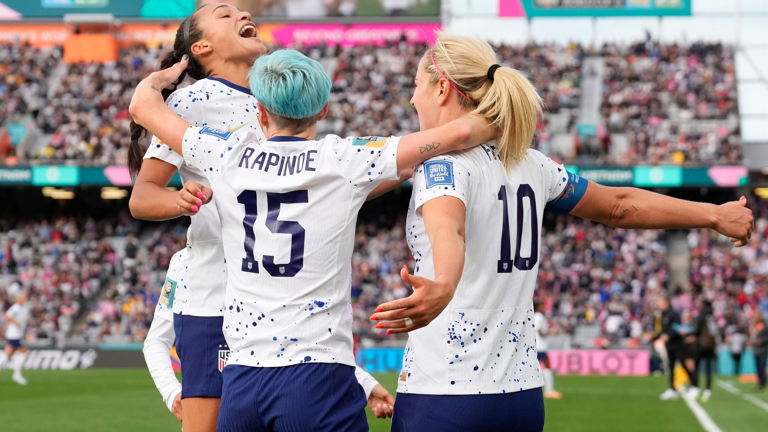 United States' Lindsey Horan, right, celebrates with Sophia Smith, left, and Megan Rapinoe after scoring during the Women's World Cup soccer match between the United States and Vietnam at Eden Park in Auckland, New Zealand, Saturday, July 22, 2023. (AP Photo/Abbie Parr)