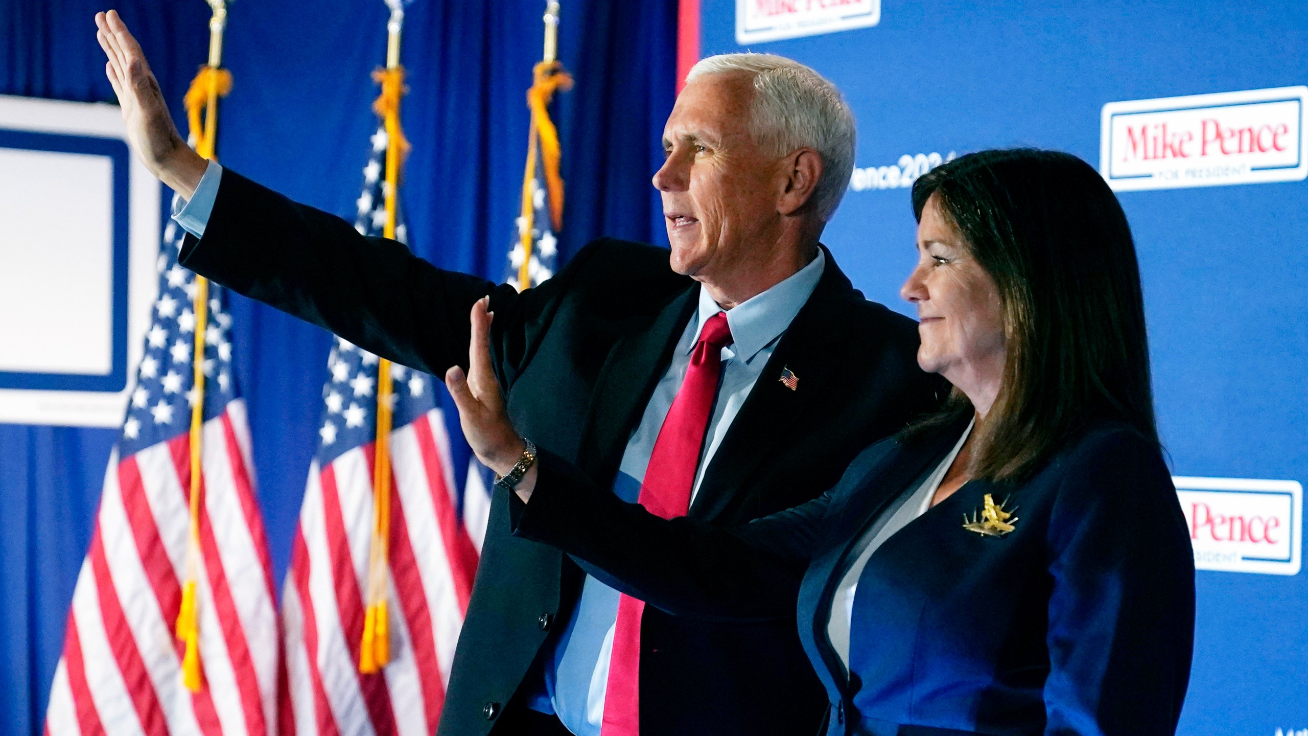 FILE - Republican presidential candidate former Vice President Mike Pence waves after a campaign stop with his wife Karen, June 9, 2023, in Derry, N.H. Weary Republicans who acknowledge Donald Trump's dominance, across New Hampshire are fighting to stop the former president from winning the first-in-the-nation primary. For now, however, they're relying on little more than hope and prayers. Look no further than Pence, who repeatedly appealed to voters' faith as he tried to resurrect his anemic presidential campaign while courting a few dozen voters in a former state lawmaker's backyard. (AP Photo/Charles Krupa, File)