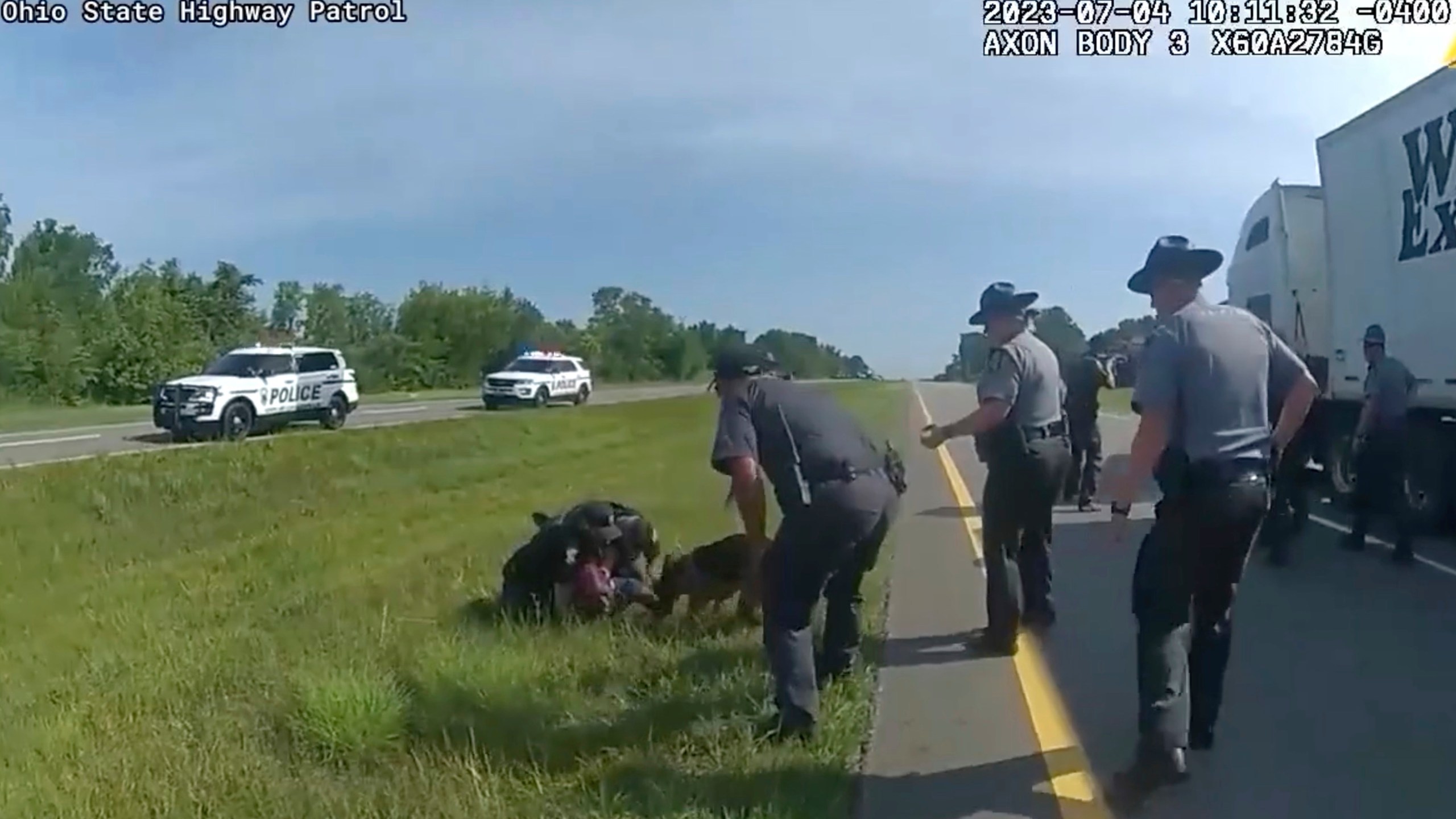 This image taken from police body cam video shows a police dog attacking Jadarrius Rose, 23, of Memphis, Tennessee on Tuesday, July 4, 2023, in Circleville, Ohio. An investigation has been launched into why an Ohio officer allowed his police dog to attack a truck driver who was surrendering with his hands raised, despite State Highway Patrol troopers urging the officer to hold the dog back. (Ohio State Highway Patrol via AP)