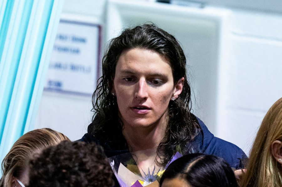 FILE - Pennsylvania's Lia Thomas looks on as she celebrates senior day with her teammates during a swim meet, on Jan. 8, 2022, in Philadelphia. In March 2022, American swimmer Lia Thomas won the women's 500-yard freestyle at the NCAA championships in Atlanta, becoming the first transgender woman to claim a national title in swimming.(AP Photo/Chris Szagola, File)