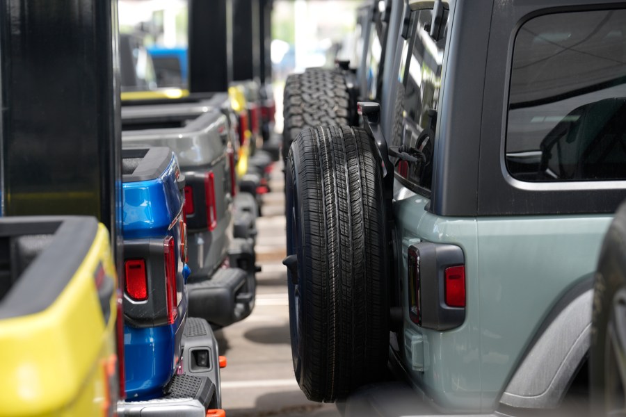 Unsold 2023 Gladiator pickup trucks, left, sit on display with Wrangler sports-utility vehicles at a Jeep dealership Sunday, June 18, 2023, in Englewood, Colo. On Tuesday, the Conference Board reports on U.S. consumer confidence for July. (AP Photo/David Zalubowski)