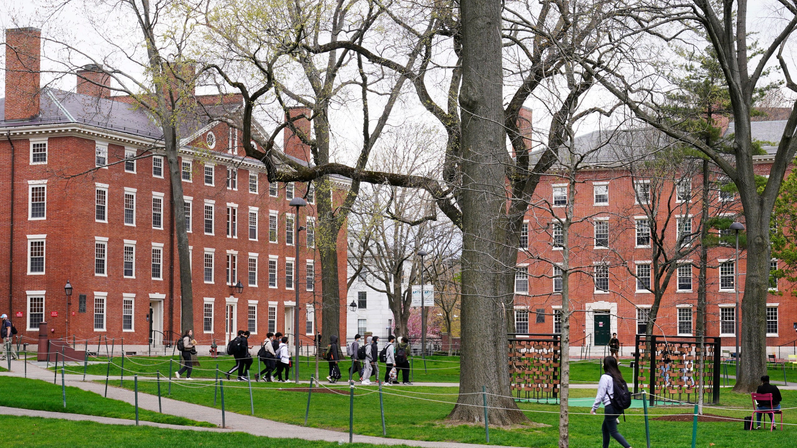 FILE - Students walk through Harvard Yard, April 27, 2022, on the campus of Harvard University in Cambridge, Mass. On Monday, July 24, 2023, the U.S. Department of Education opened an investigation into Harvard University's policies on legacy admissions, which give an edge to applicants with family ties to alumni. (AP Photo/Charles Krupa, File)