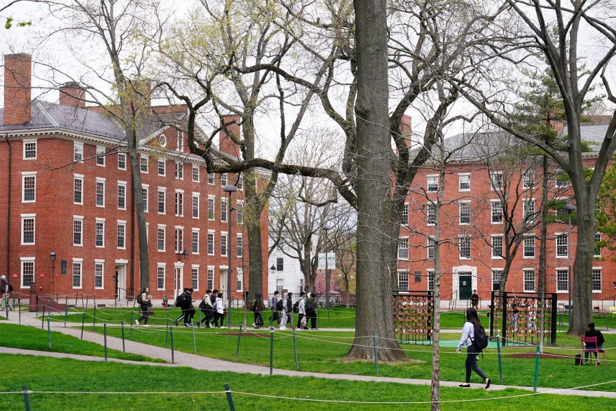 FILE - Students walk through Harvard Yard, April 27, 2022, on the campus of Harvard University in Cambridge, Mass. On Monday, July 24, 2023, the U.S. Department of Education opened an investigation into Harvard University's policies on legacy admissions, which give an edge to applicants with family ties to alumni. (AP Photo/Charles Krupa, File)