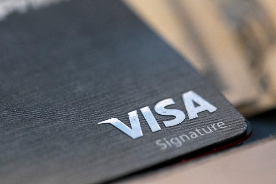 FILE-This Aug. 11, 2019, file photo shows a Visa logo on a credit card in New Orleans. Visa reports earnings on Tuesday July 25, 2023. (AP Photo/Jenny Kane, File)