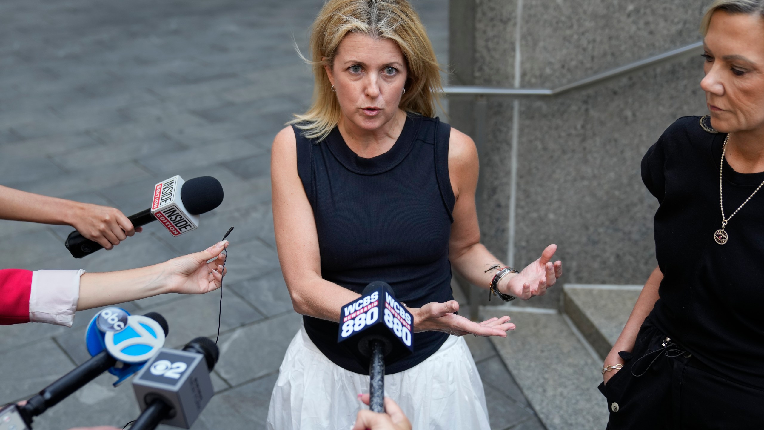 Sexual assault survivors Laurie Kanyok, second from right, and Amy Yoney, right, speak to members of the media during a break in sentencing proceedings for convicted sex offender Robert Hadden outside Federal Court, Monday, July 24, 2023, in New York. The former obstetrician was convicted of sexually abusing multiple patients over several decades. (AP Photo/John Minchillo)