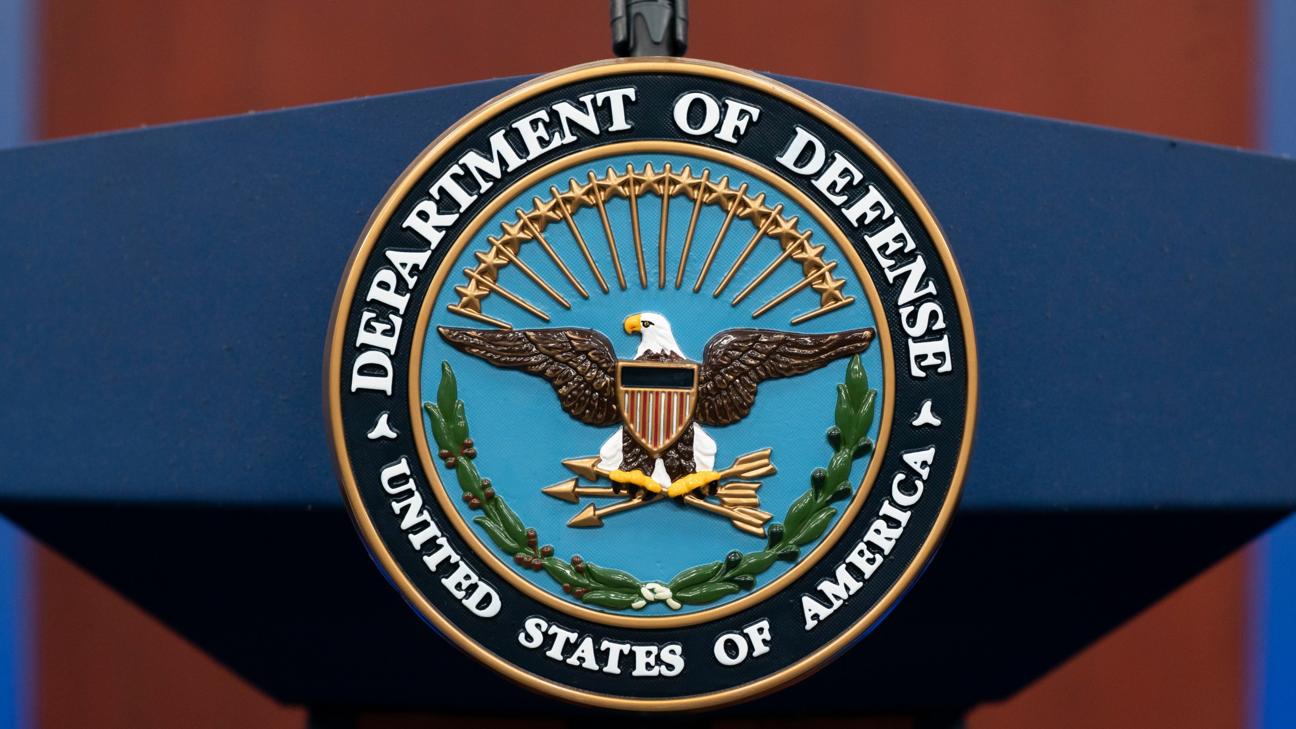 FILE - The seal of the Department of Defense is seen on the podium at the Pentagon, Sept. 27, 2022, in Washington. President Joe Biden will sign an executive order that gives decisions on the prosecution of serious military crimes, including sexual assault, to independent military attorneys, taking that power away from victims' commanders. (AP Photo/Alex Brandon, File)