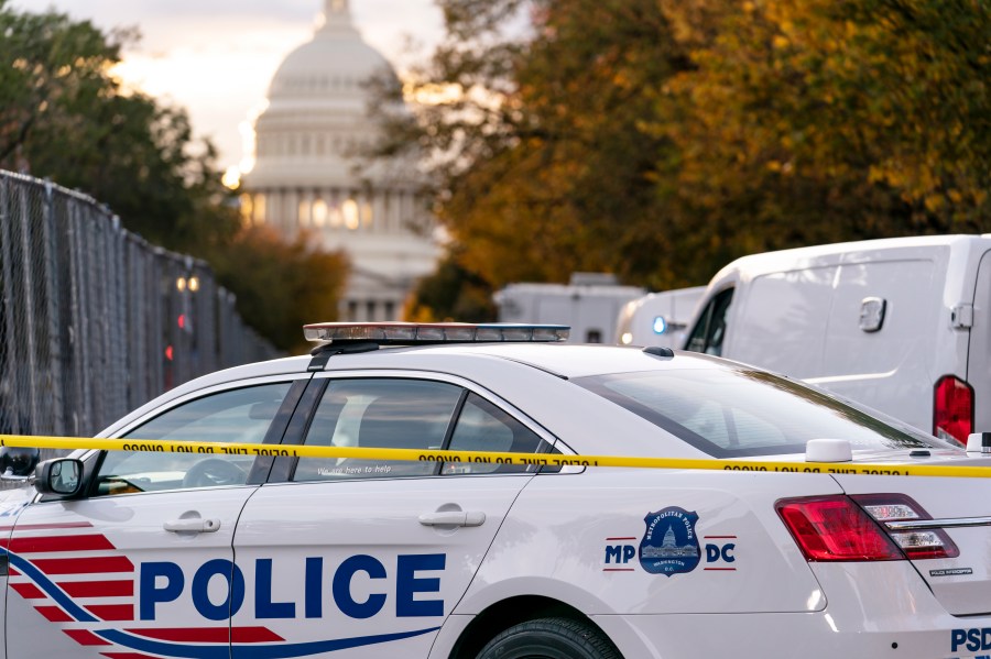 FILE - Washington Metropolitan Police investigate near the Supreme Court and Capitol after reports of a suspicious vehicle in which two men and a woman were detained with guns, Oct. 19, 2022, in Washington. District of Columbia Mayor Muriel Bowser's government has been struggling to handle steadily rising violent crime rates in recent years. Although police and city officials point out that overall crime rates have stayed steady, murders and carjackings have spiked — stoking public anxiety. (AP Photo/J. Scott Applewhite, File)