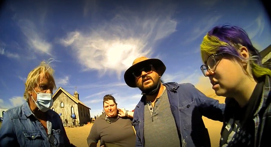 In this screen grab from lapel camera video provided by the Santa Fe County Sheriff's Office, movie set armorer Hannah Gutierrez-Reed, right, speaks with a sheriff’s deputy as other colleagues stand with her on the set of the western move “Rust,” shortly after the fatal shooting of cinematographer Halyna Hutchins by Alec Baldwin during a rehearsal, Oct. 21, 2021, in New Mexico. A judge will consider allegations of due process violations in the prosecution of Gutierrez-Reed, who is accused of involuntary manslaughter and evidence tampering in the death of Hutchins, at an online court hearing scheduled Tuesday, Aug. 1, 2023. Charges against Baldwin in connection with the shooting were dismissed in April. (Santa Fe County Sheriff's Office via AP)