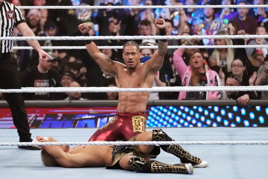 FILE - Wrestler Carmelo Hayes raises his arms after defeating Akira Tozawa during the WWE Monday Night RAW event, Monday, March 6, 2023, in Boston. Federal law enforcement agents executed a search warrant and served a federal grand jury subpoena to WWE Executive Chairman Vince McMahon last month, July 2023, according to a regulatory filing. McMahon is also taking medical leave from the sports entertainment company following recent spinal surgery. (AP Photo/Charles Krupa, File)