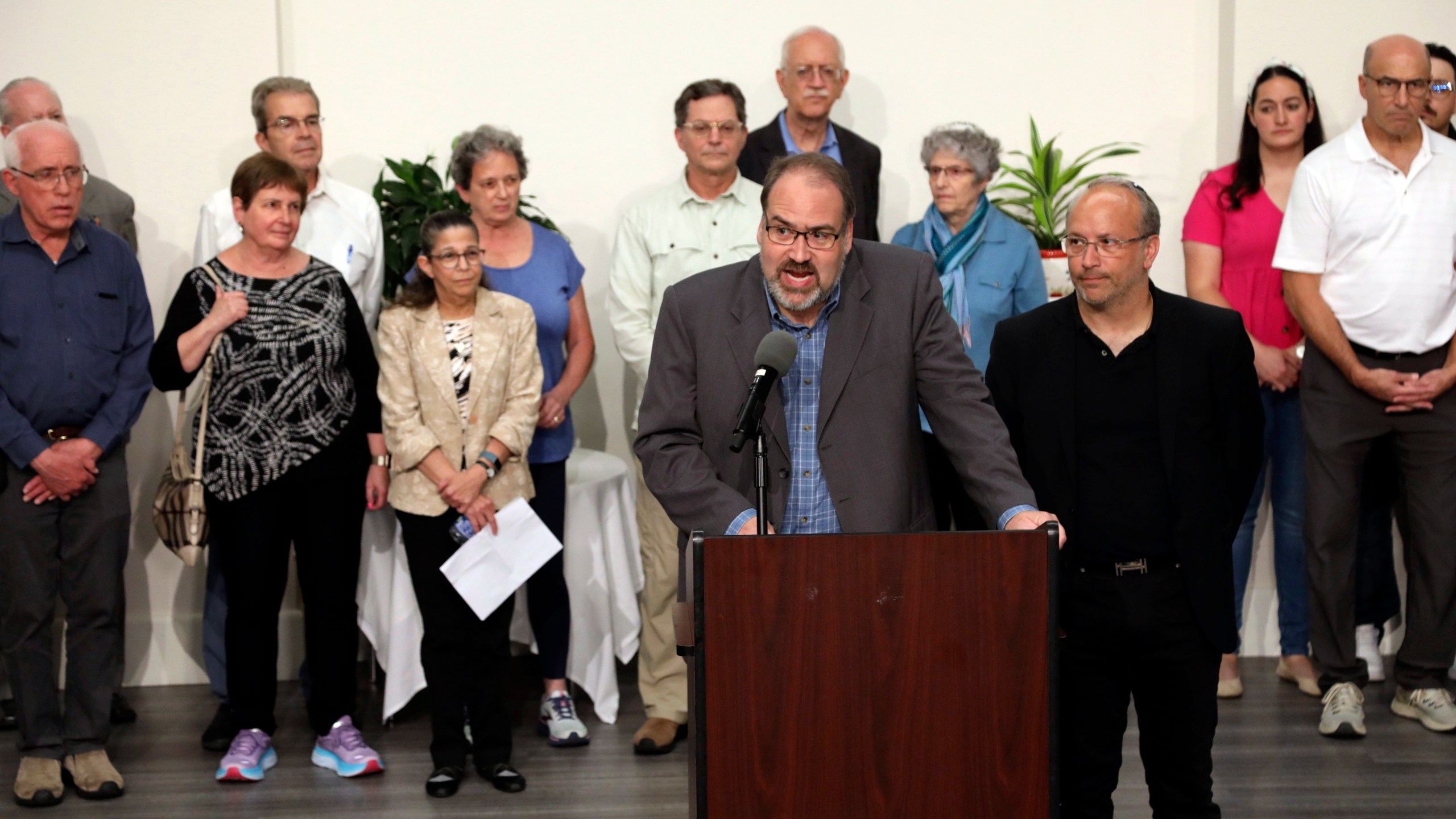 Howard Fienberg speaks to the media surrounded by victims and families of victims following the sentencing of Robert Bowers at the Jewish Community Center in Pittsburgh, Wednesday, Aug 2, 2023. Bowers was sentenced to death for killing 11 people at the Tree of Life synagogue in Pittsburgh in 2018. (AP Photo/Rebecca Droke)