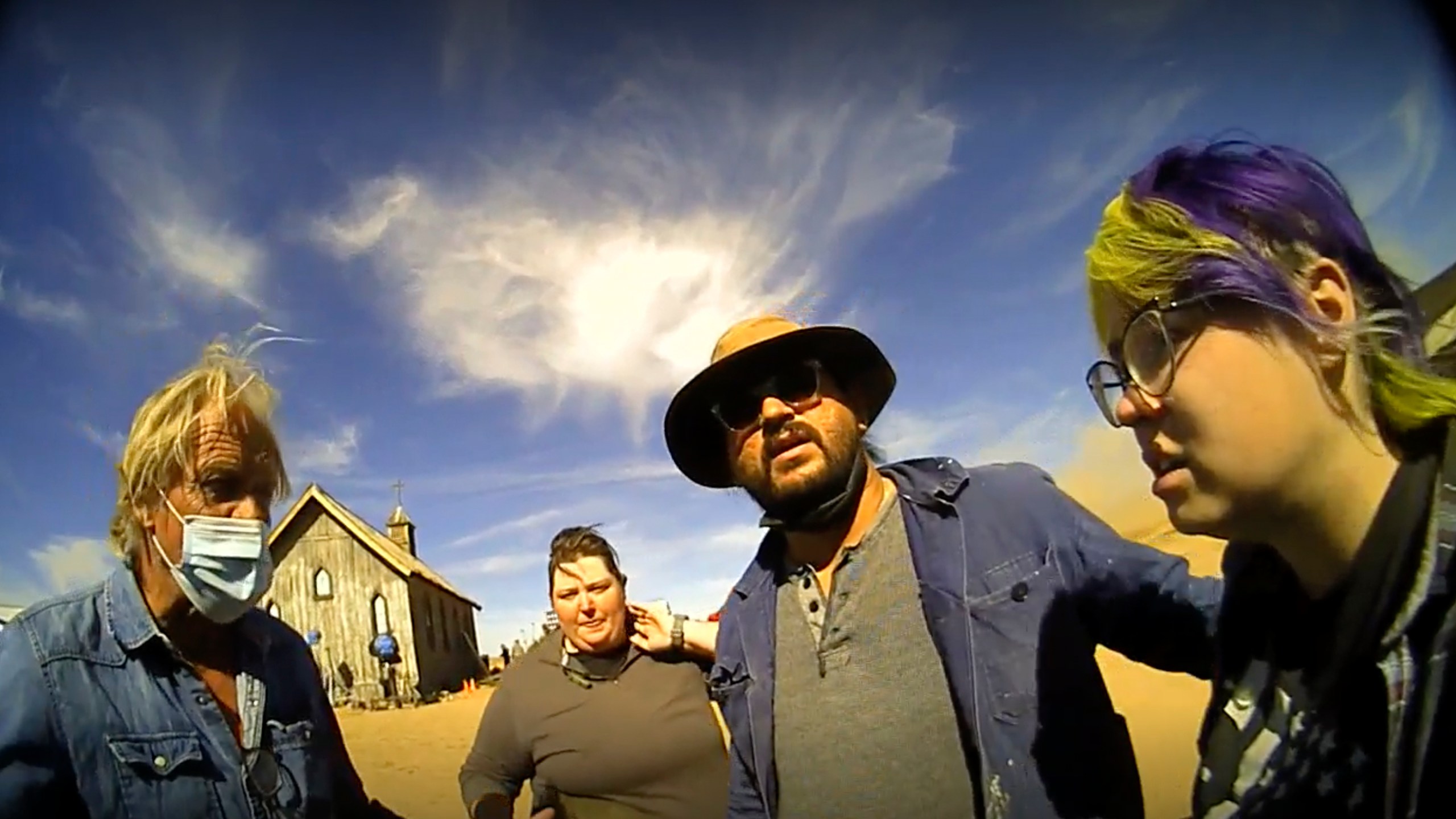 In this screen grab from lapel camera video provided by the Santa Fe County Sheriff's Office, movie set armorer Hannah Gutierrez-Reed, right, speaks with a sheriff’s deputy as other colleagues stand with her on the set of the western move “Rust,” shortly after the fatal shooting of cinematographer Halyna Hutchins by Alec Baldwin during a rehearsal, Oct. 21, 2021, in New Mexico. A judge will consider allegations of due process violations in the prosecution of Gutierrez-Reed, who is accused of involuntary manslaughter and evidence tampering in the death of Hutchins, at an online court hearing scheduled Tuesday, Aug. 1, 2023. Charges against Baldwin in connection with the shooting were dismissed in April. (Santa Fe County Sheriff's Office via AP)