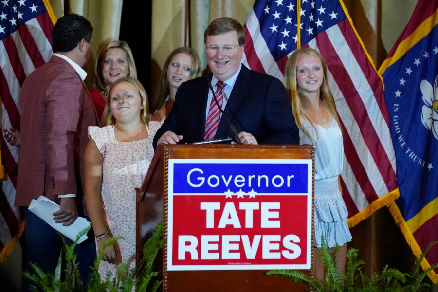 Republican Mississippi Gov. Tate Reeves leads his family to the podium to address supporters in Jackson, Miss., after winning the party primary Tuesday, Aug. 8, 2023. Reeves defeated two challengers for the party nomination. (AP Photo/Rogelio V. Solis)