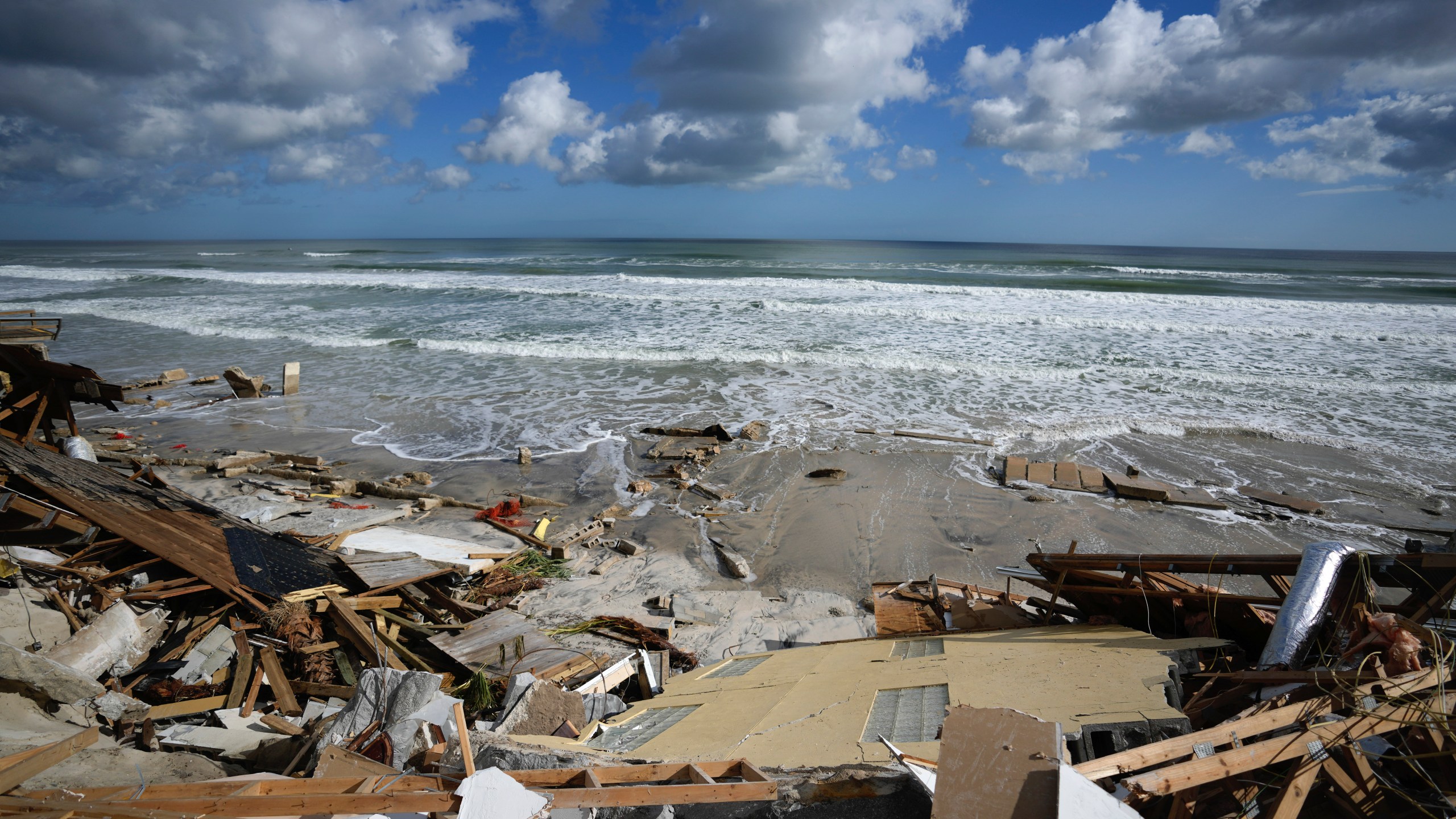 FILE - A piece of wall is seen amid the wreckage of Nina Lavigna's beachfront home, after half of her house collapsed following Hurricane Nicole, Nov. 12, 2022, in Wilbur-By-The-Sea, Fla. Record hot ocean temperatures and a tardy El Nino are doubling the chances of a nasty Atlantic hurricane season this summer and fall, the National Oceanic and Atmospheric Administration said Thursday, Aug. 10, 2023. (AP Photo/Rebecca Blackwell, File)