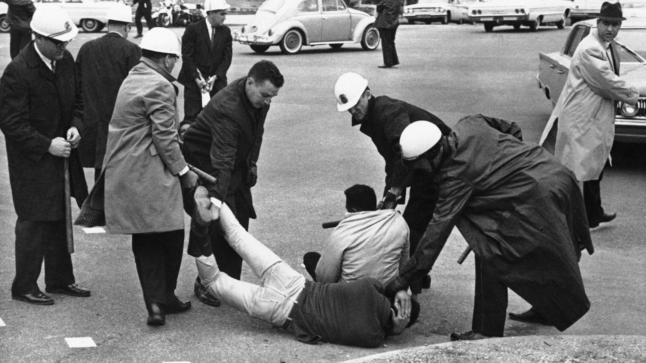 FILE - Police carry off two men who were part of a sit down group at Montgomery, Ala. on March 11, 1965. Hundreds had marched on the Capitol yesterday and several attempted to continue it today. (AP Photo/File)