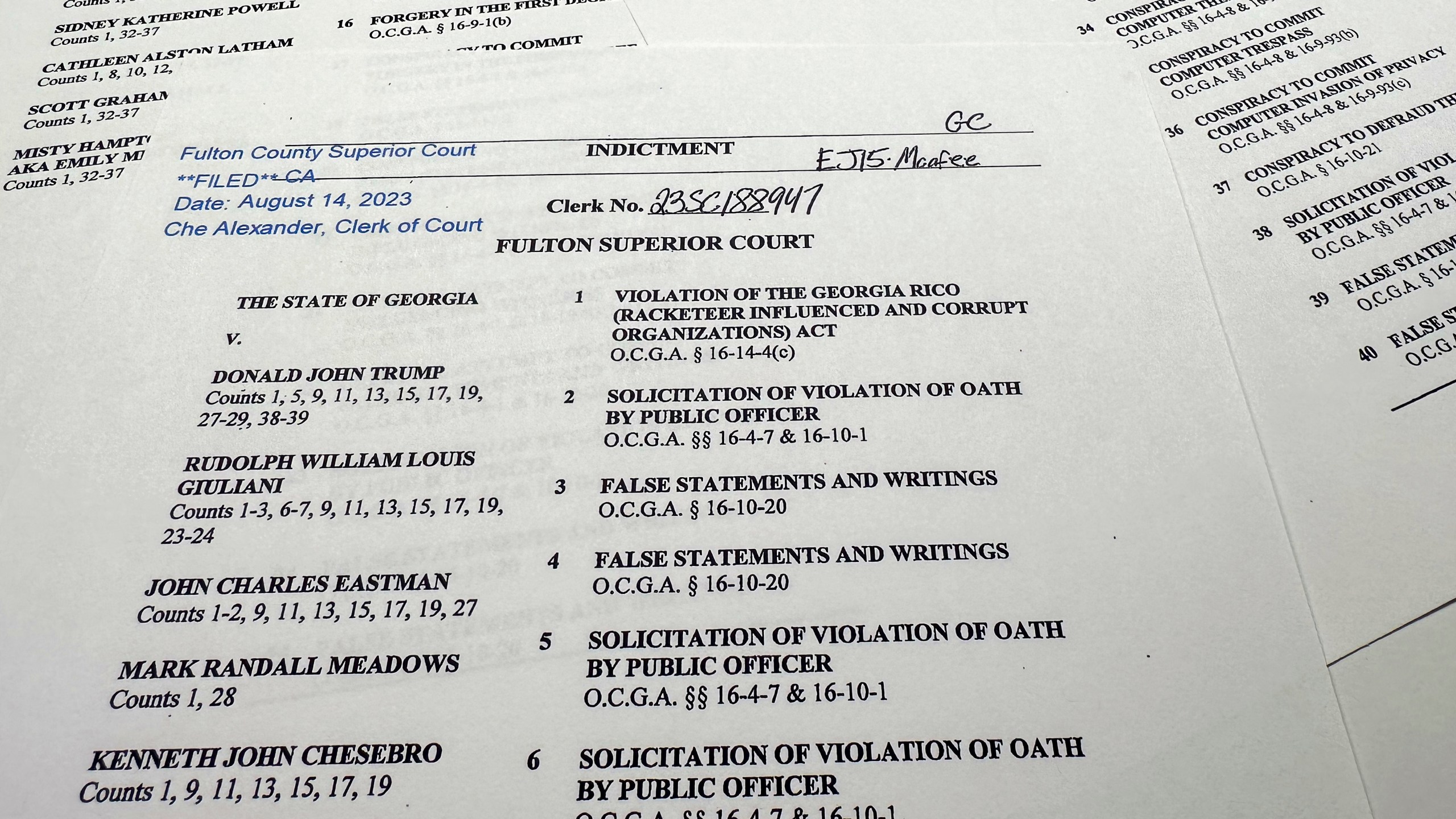 The indictment in Georgia against former President Donald Trump is photographed Monday, Aug. 14, 2023. Trump and several allies have been indicted in Georgia over efforts to overturn his 2020 election loss in the state. The criminal case announced Monday is the fourth brought against the ex-president in a matter of months. (AP Photo/Jon Elswick)