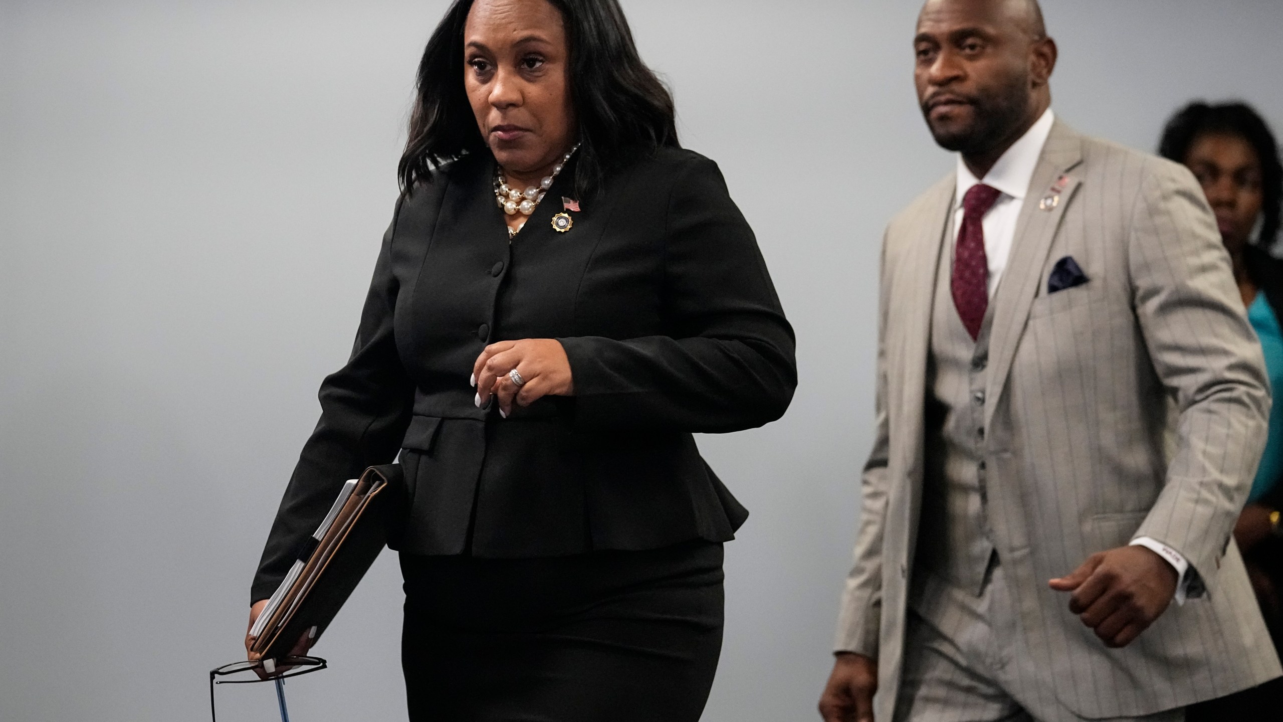 Fulton County District Attorney Fani Willis enteres a room in the Fulton County Government Center ahead of a news conference, Monday, Aug. 14, 2023, in Atlanta. Donald Trump and several allies have been indicted in Georgia over efforts to overturn his 2020 election loss in the state. (AP Photo/John Bazemore)