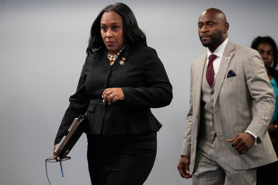 Fulton County District Attorney Fani Willis enteres a room in the Fulton County Government Center ahead of a news conference, Monday, Aug. 14, 2023, in Atlanta. Donald Trump and several allies have been indicted in Georgia over efforts to overturn his 2020 election loss in the state. (AP Photo/John Bazemore)