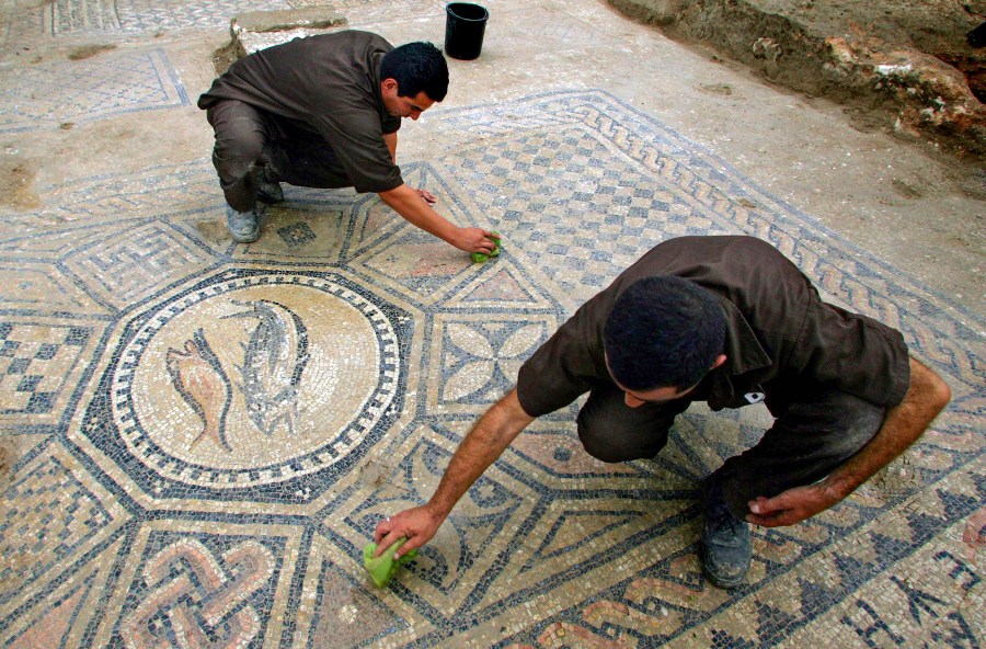 File - Prisoners work at a nearly 1,800-year-old decorated floor from an early Christian prayer hall discovered by Israeli archaeologists on Sunday, November 6, 2005 in the Megiddo prison. Israeli officials are considering uprooting the mosaic and loaning it to the controversial Museum of the Bible in Washington D.C., a proposal that has upset archaeologists and underscores the hardline government's close ties with evangelical Christians in the U.S. (AP Photo/Ariel Schalit, File)