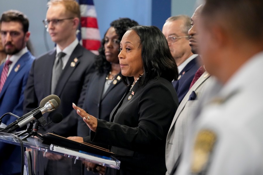 Fulton County District Attorney Fani Willis, center, speaks in the Fulton County Government Center during a news conference, Monday, Aug. 14, 2023, in Atlanta. Donald Trump and several allies have been indicted in Georgia over efforts to overturn his 2020 election loss in the state. (AP Photo/John Bazemore)