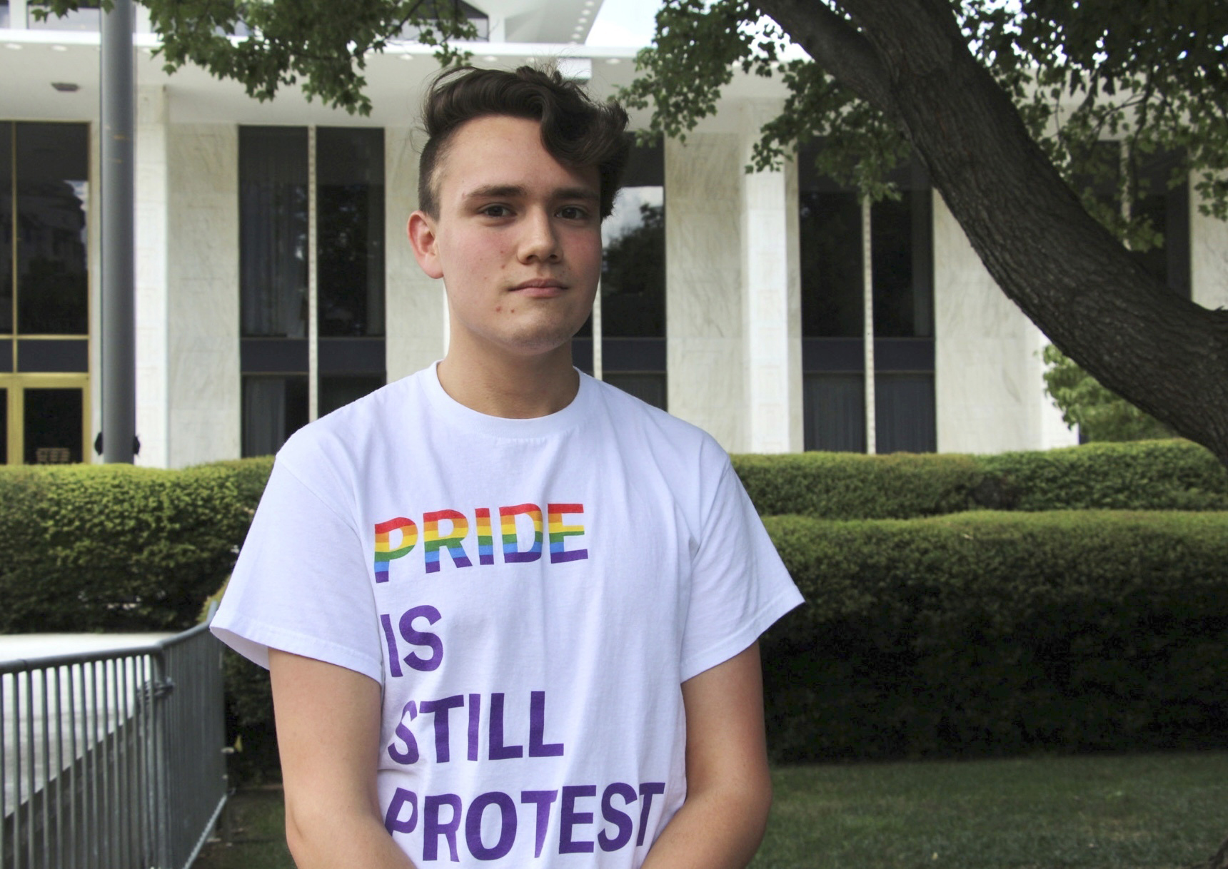 North Carolina State University student and LGBTQ+ rights activist Nathaniel Dibble, 19, poses for a portrait outside the state Legislative Building in Raleigh, N.C., Wednesday, Aug. 16, 2023. Republican state lawmakers will attempt later Wednesday to override the Democratic governor's veto of legislation banning gender-affirming health care for minors. (AP Photo/Hannah Schoenbaum)