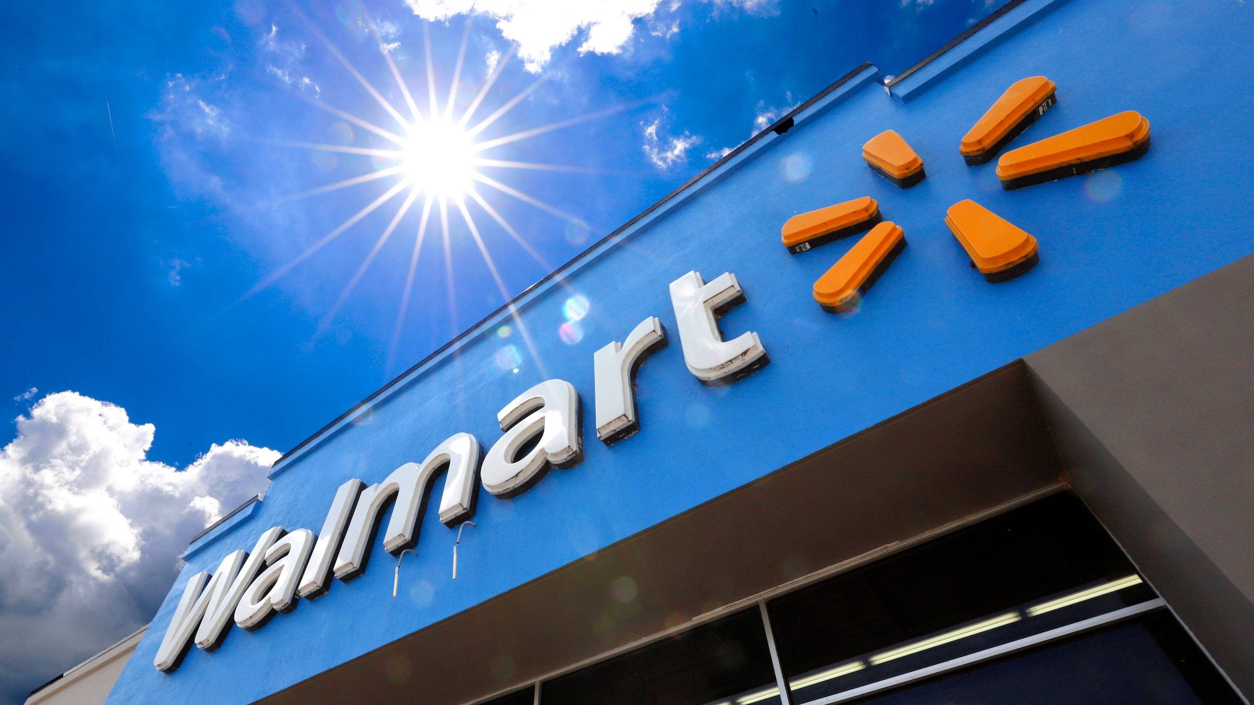 FILE - The entrance to a Walmart store is shown on June 25, 2019 in Pittsburgh. Walmart reports earning on Thursday. (AP Photo/Gene J. Puskar, File)