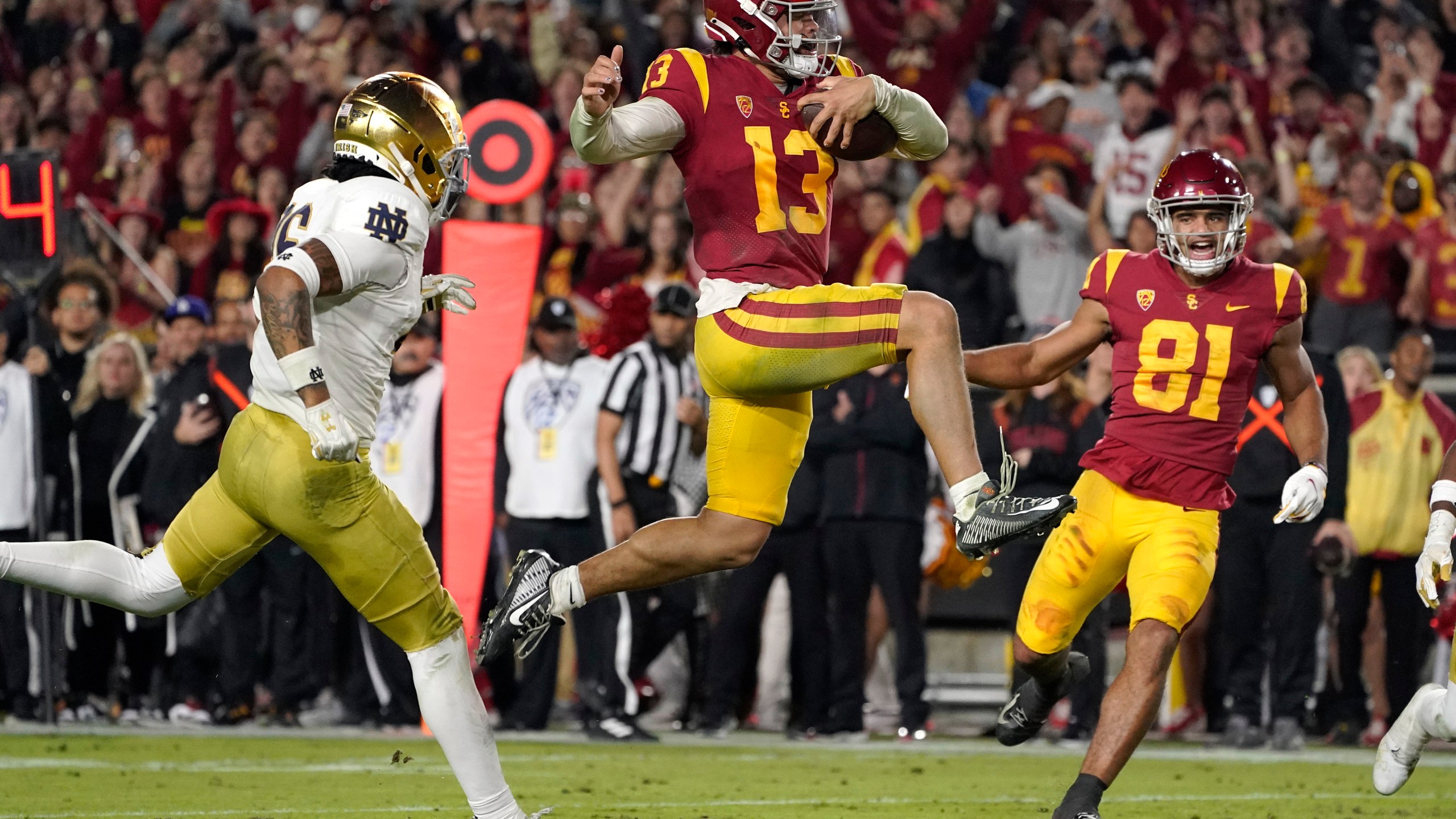 FILE - Southern California quarterback Caleb Williams jumps in for a touchdown as Notre Dame safety Xavier Watts, left, defends and Southern California wide receiver Kyle Ford watch during the second half of an NCAA college football game Saturday, Nov. 26, 2022, in Los Angeles. Caleb Williams was named to The Associated Press preseason All-America team, Monday, Aug. 21, 2023. (AP Photo/Mark J. Terrill, File)