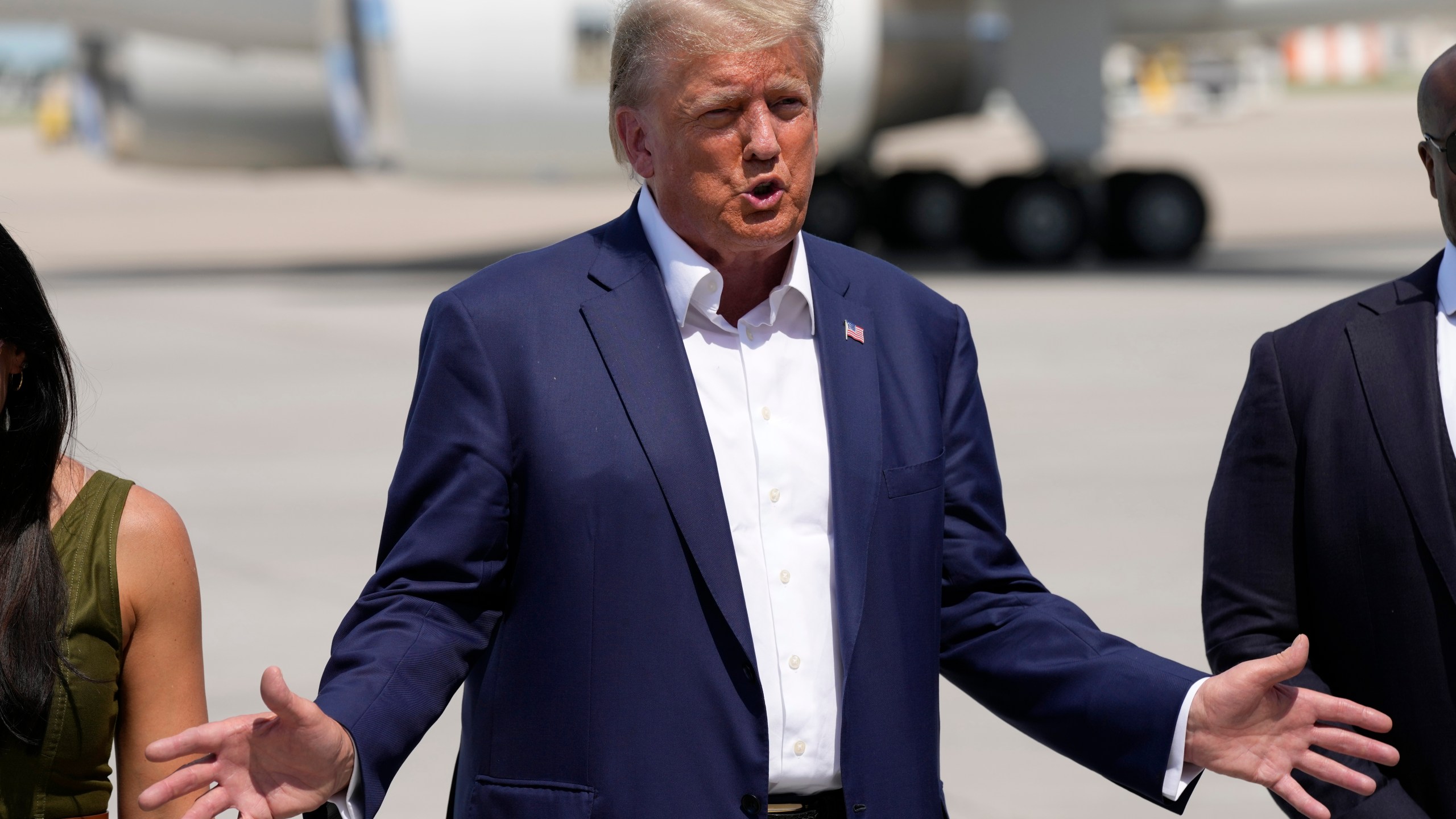 Republican presidential candidate former President Donald Trump speaks to reporters at the Des Moines International Airport after a visit to the Iowa State Fair, Saturday, Aug. 12, 2023, in Des Moines, Iowa. (AP Photo/Charlie Neibergall)