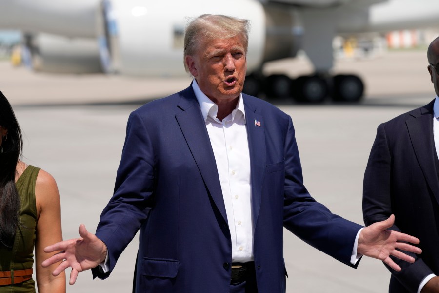 Republican presidential candidate former President Donald Trump speaks to reporters at the Des Moines International Airport after a visit to the Iowa State Fair, Saturday, Aug. 12, 2023, in Des Moines, Iowa. (AP Photo/Charlie Neibergall)