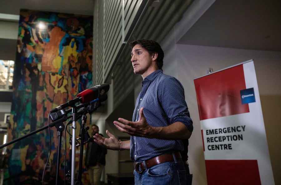 Prime Minister Justin Trudeau speaks about the wildfires in British Columbia and the Northwest Territories after visiting evacuees in Edmonton, Alberta, Friday, Aug. 18, 2023.(Jason Franson/The Canadian Press via AP)