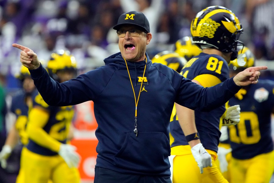 FILE - Michigan head coach Jim Harbaugh gestures during the first half of the Fiesta Bowl NCAA college football semifinal playoff game against TCU, Saturday, Dec. 31, 2022, in Glendale, Ariz. Michigan faces Ohio State on Nov. 25, 2023. This becomes huge if both the Buckeyes and Wolverines get past Big Ten title contender No. 7 Penn State. (AP Photo/Rick Scuteri, File)