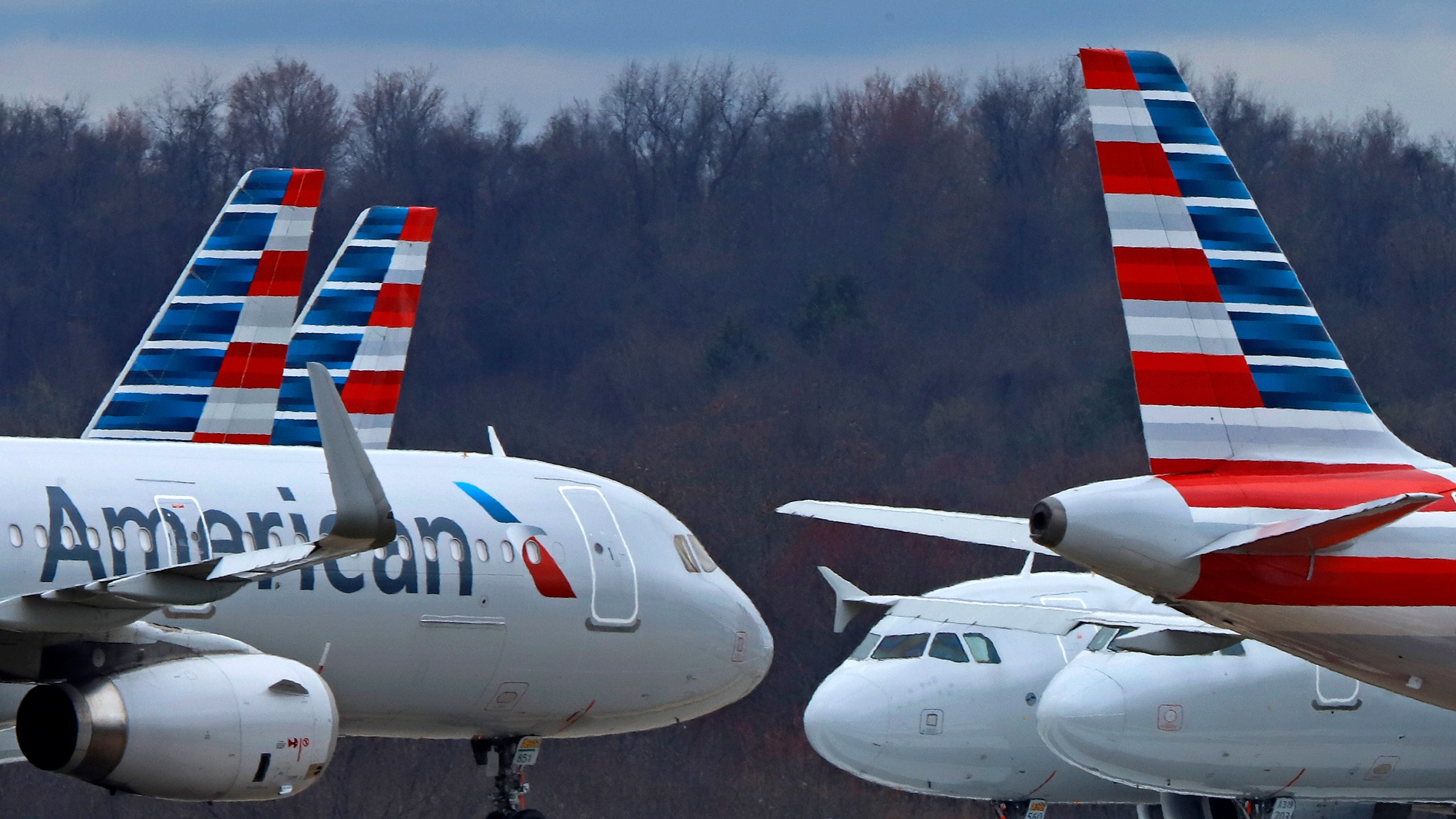 FILE - American Airlines planes are parked at Pittsburgh International Airport on March 31, 2020, in Imperial, Pa. Pilots at American Airlines have approved a new contract that will raise their pay 41% over four years. Their union, the Allied Pilots Association, said Monday, Aug. 21, 2023 that the vote was 73% in favor of ratifying the contract. (AP Photo/Gene J. Puskar, file)