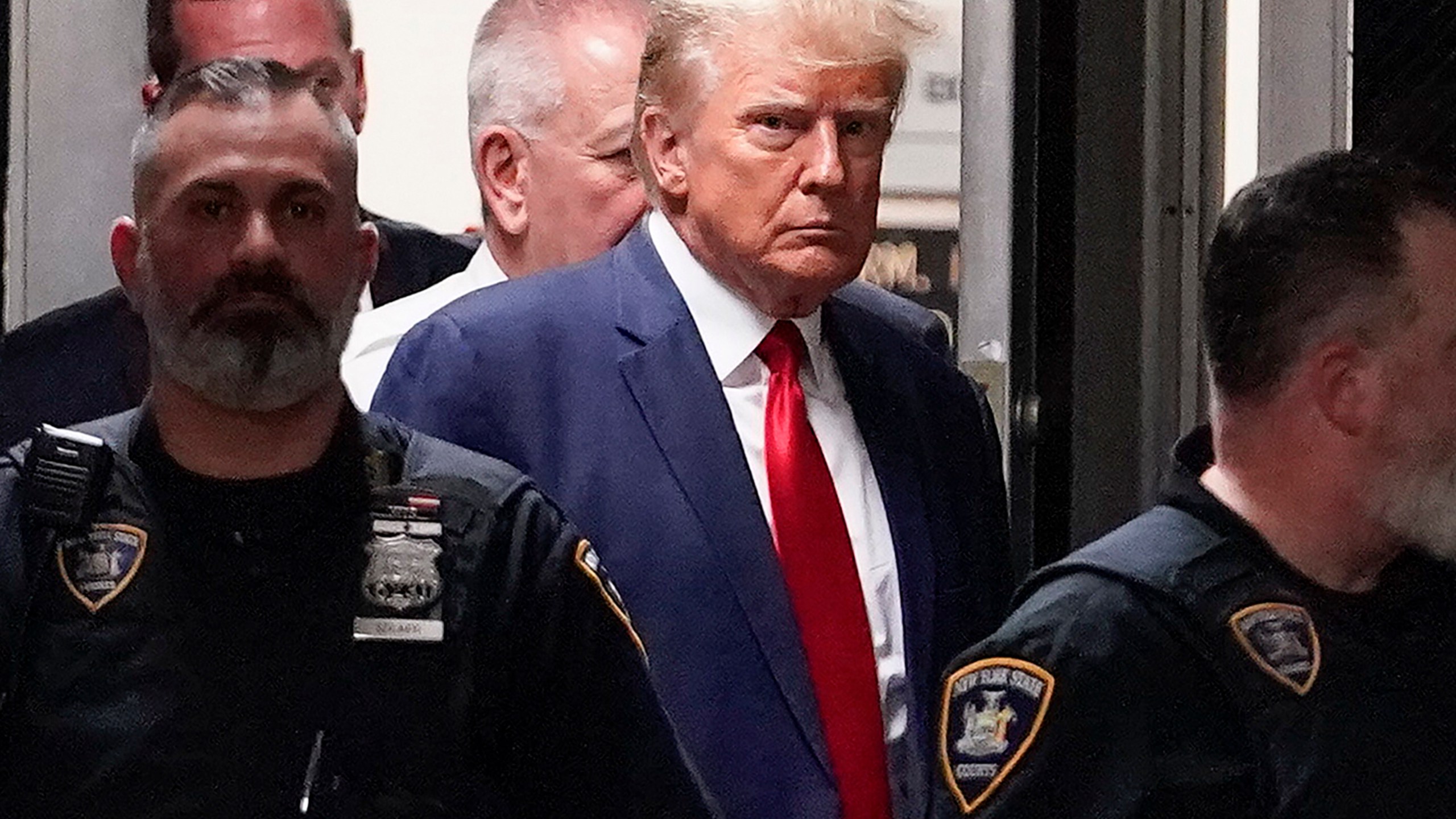 FILE - Former President Donald Trump is escorted to a courtroom, April 4, 2023, in New York. Trump’s bond has been set at $200,000 in the Georgia case accusing the former president of scheming to overturn his 2020 election loss. The bond agreement was outlined in a court filing signed by Fulton County District Attorney Fani Willis and Trump’s defense attorneys. (AP Photo/Mary Altaffer, File)