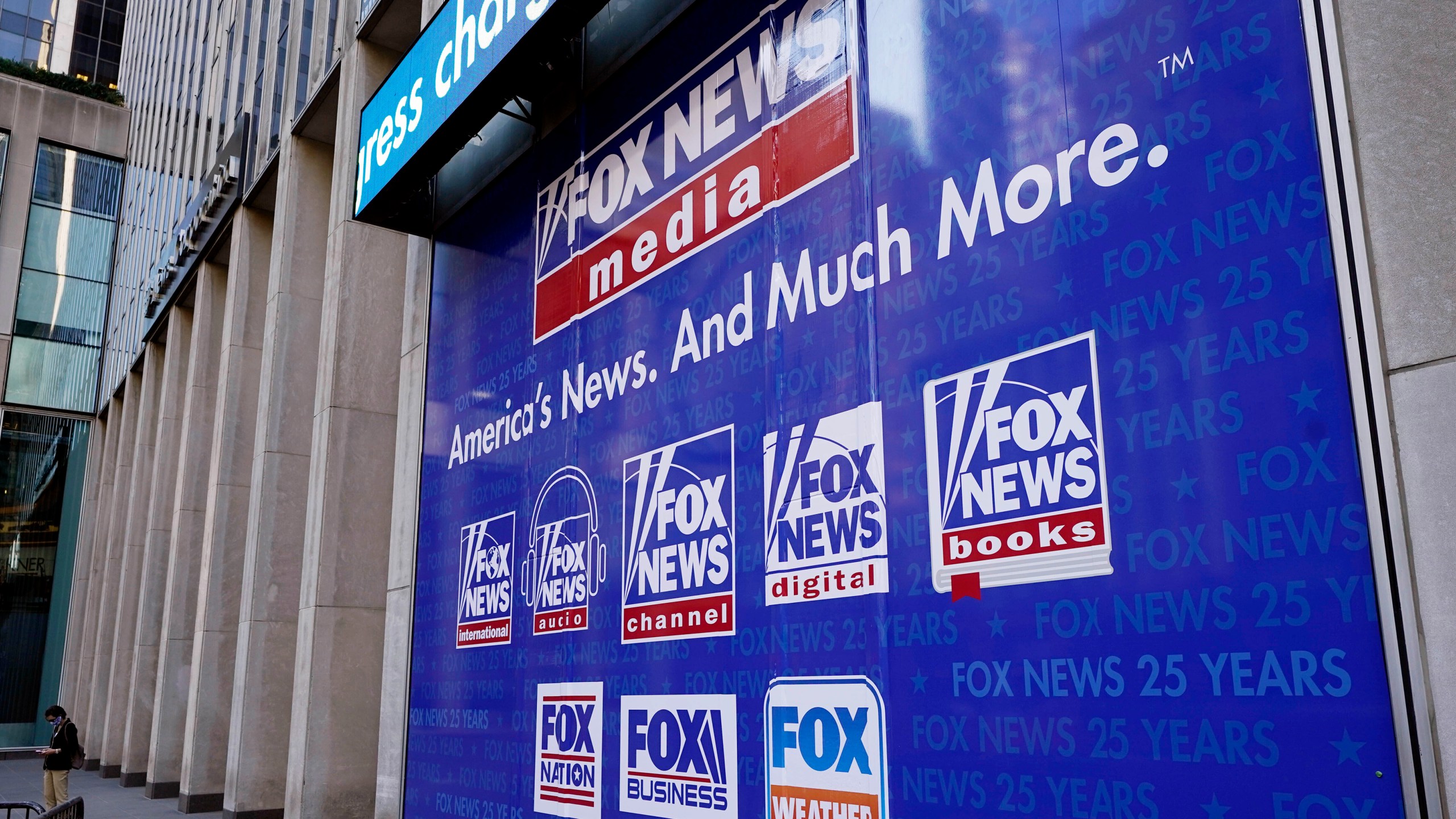 FILE - Signage at News Corporation headquarters is shown in this photo, in New York, Oct. 20, 2021. The first 2024 Republican presidential debate on Wednesday, Aug. 23, 2023, is being moderated by Fox News hosts Bret Baier and Martha MacCallum. (AP Photo/Richard Drew, File)