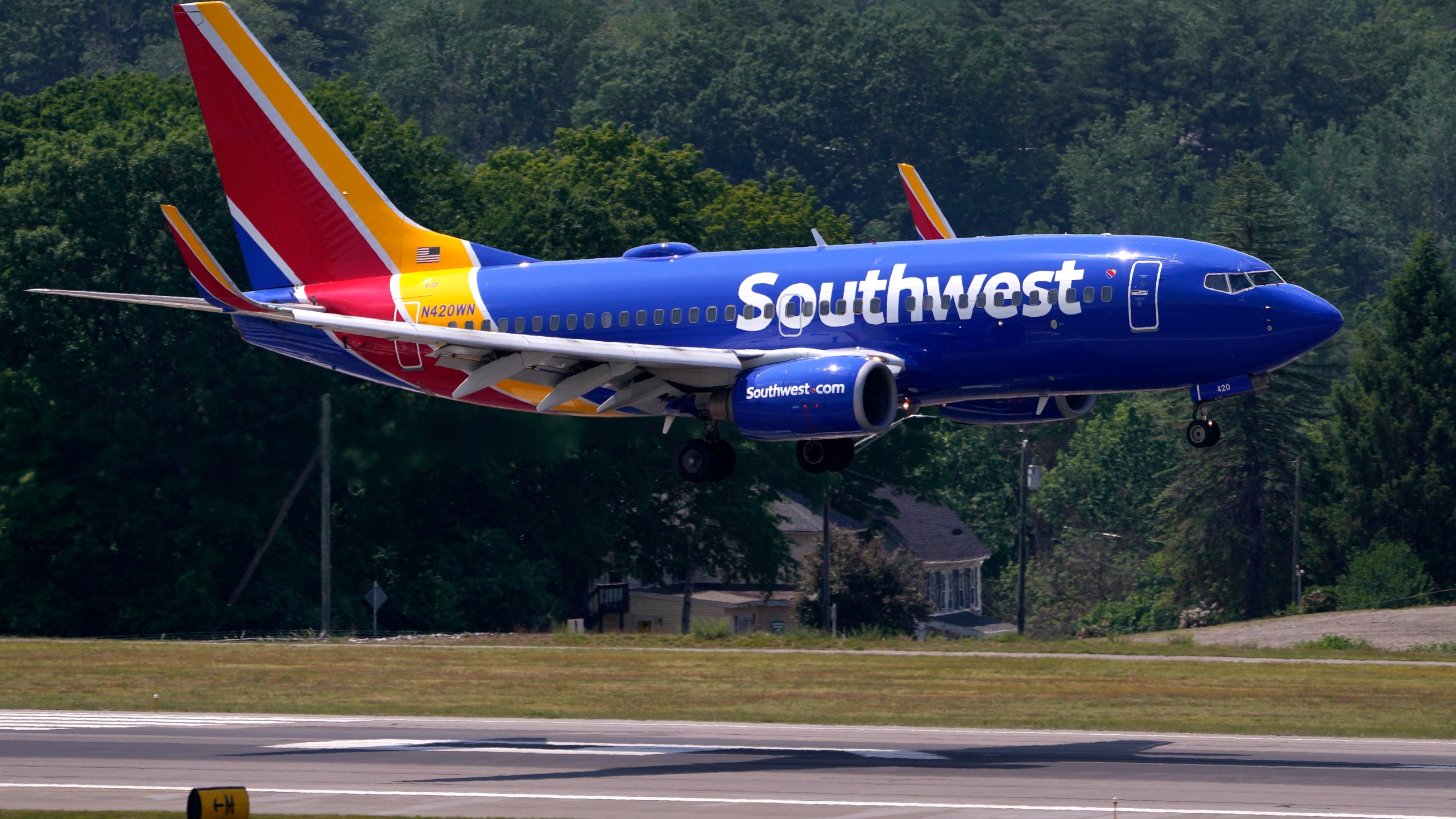 FILE - Southwest Airlines Boeing 737 lands at Manchester Boston Regional Airport, June 2, 2023, in Manchester, N.H. Southwest Airlines is changing its unusual boarding system by limiting the opportunity to pay an extra fee and jump ahead of other passengers in the race for the best seats. The airline said Wednesday, Aug. 23, that it has not dropped “EarlyBird” entirely from any flights, but it is “limiting the number of spots available for purchase on certain flights, routes, or days, as we work on product enhancements.” (AP Photo/Charles Krupa, File)