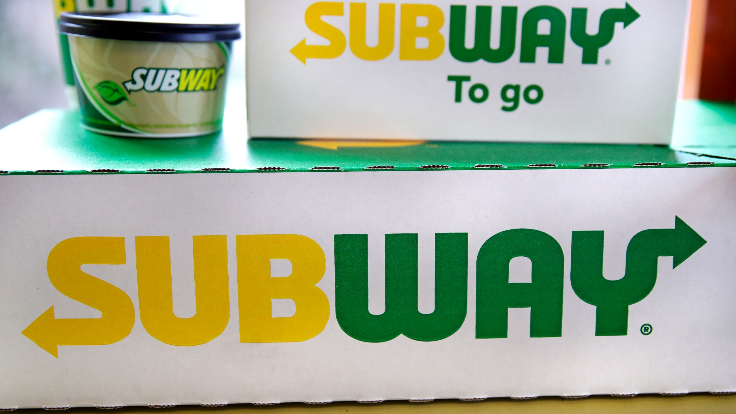 File - The Subway logo is seen on takeout boxes at a restaurant in Londonderry, N.H., on Feb. 23, 2018. The sandwich chain said Thursday it will be sold to the private equity firm Roark Capital. Terms of the deal weren't disclosed. (AP Photo/Charles Krupa, File)