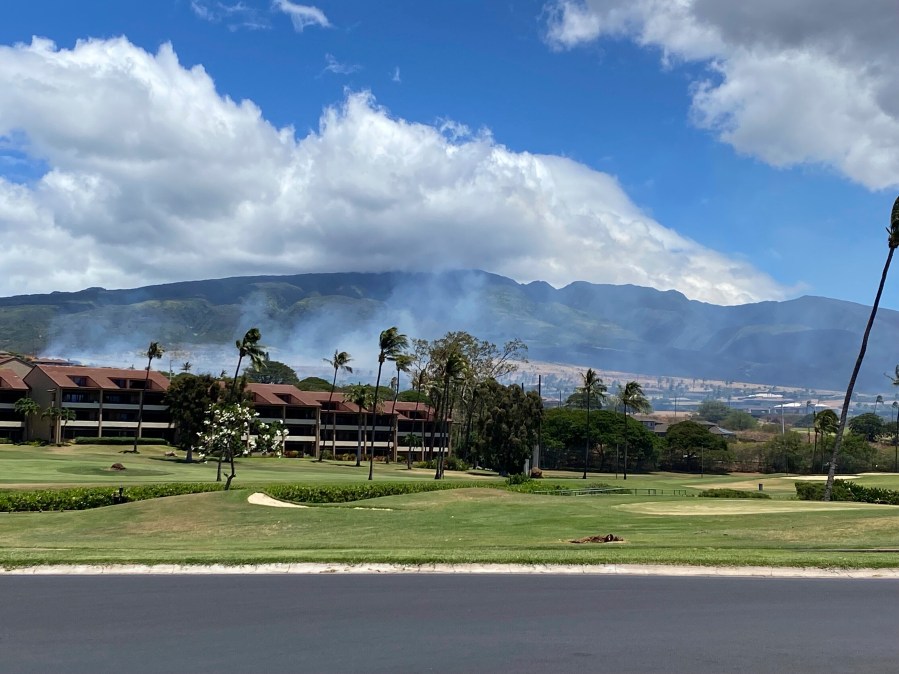 Smoke rises in the hills above the Kaanapali resort hotel area of Lahaina, Hawaii on Saturday, August 26, 2023. A brush fire on Saturday prompted Maui authorities to evacuate residents from a neighborhood of Lahaina, just a few miles from the site recently ravaged by blazes. (Cindy Ellen Russell/Honolulu Star-Advertiser via AP)