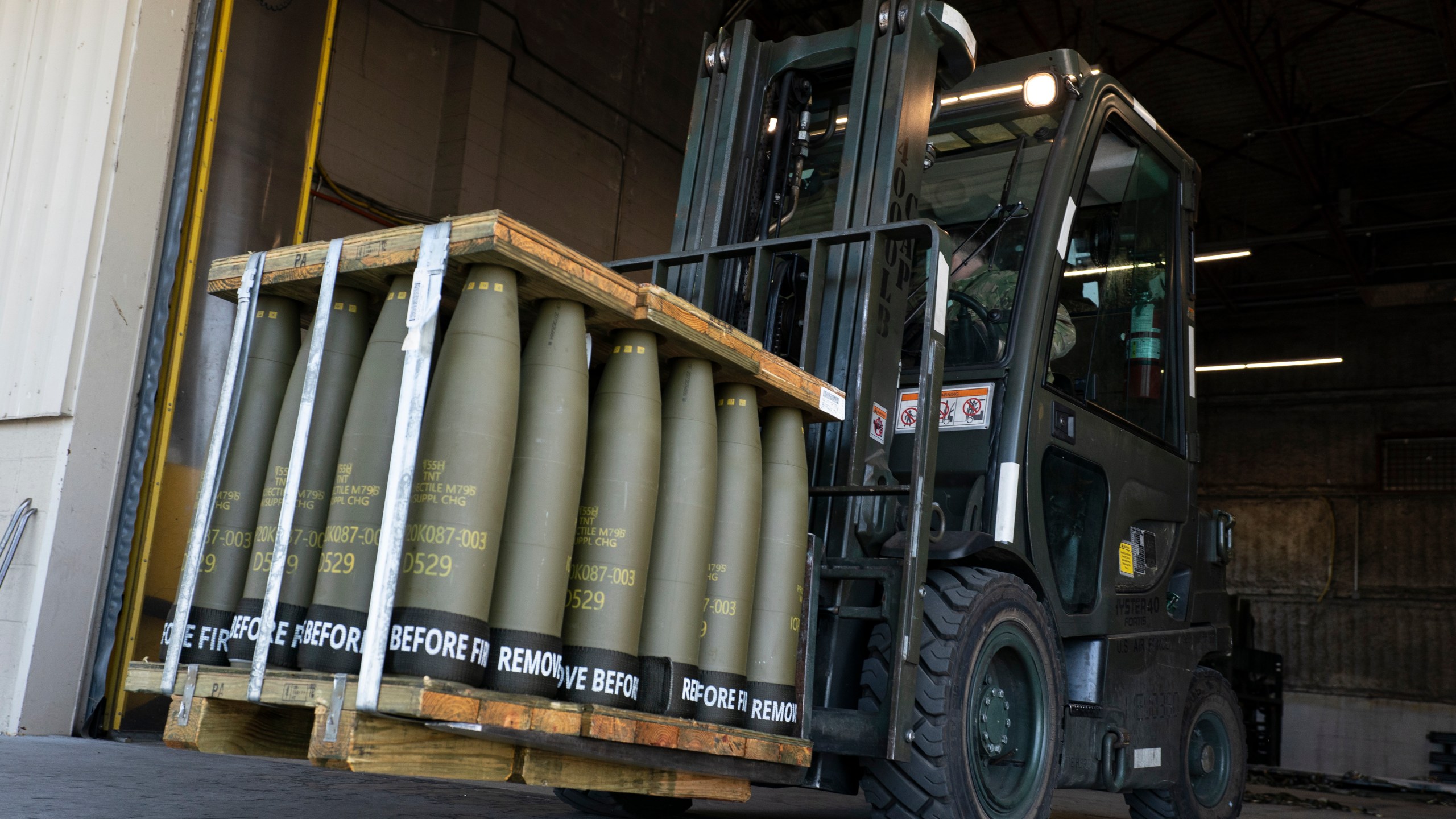 FILE - Airmen with the 436th Aerial Port Squadron use a forklift to move 155 mm shells ultimately bound for Ukraine, April 29, 2022, at Dover Air Force Base, Del. The Biden administration will send an additional $250 million in weapons and ammunition to Ukraine as part of its ongoing support of Kyiv's counteroffensive. The weapons will be drawn from existing U.S. stockpiles, officials said Tuesday, Aug. 29, and will include mine-clearing equipment, artillery and rocket rounds, ambulances and medical gear, among other items and spare parts. (AP Photo/Alex Brandon, File)