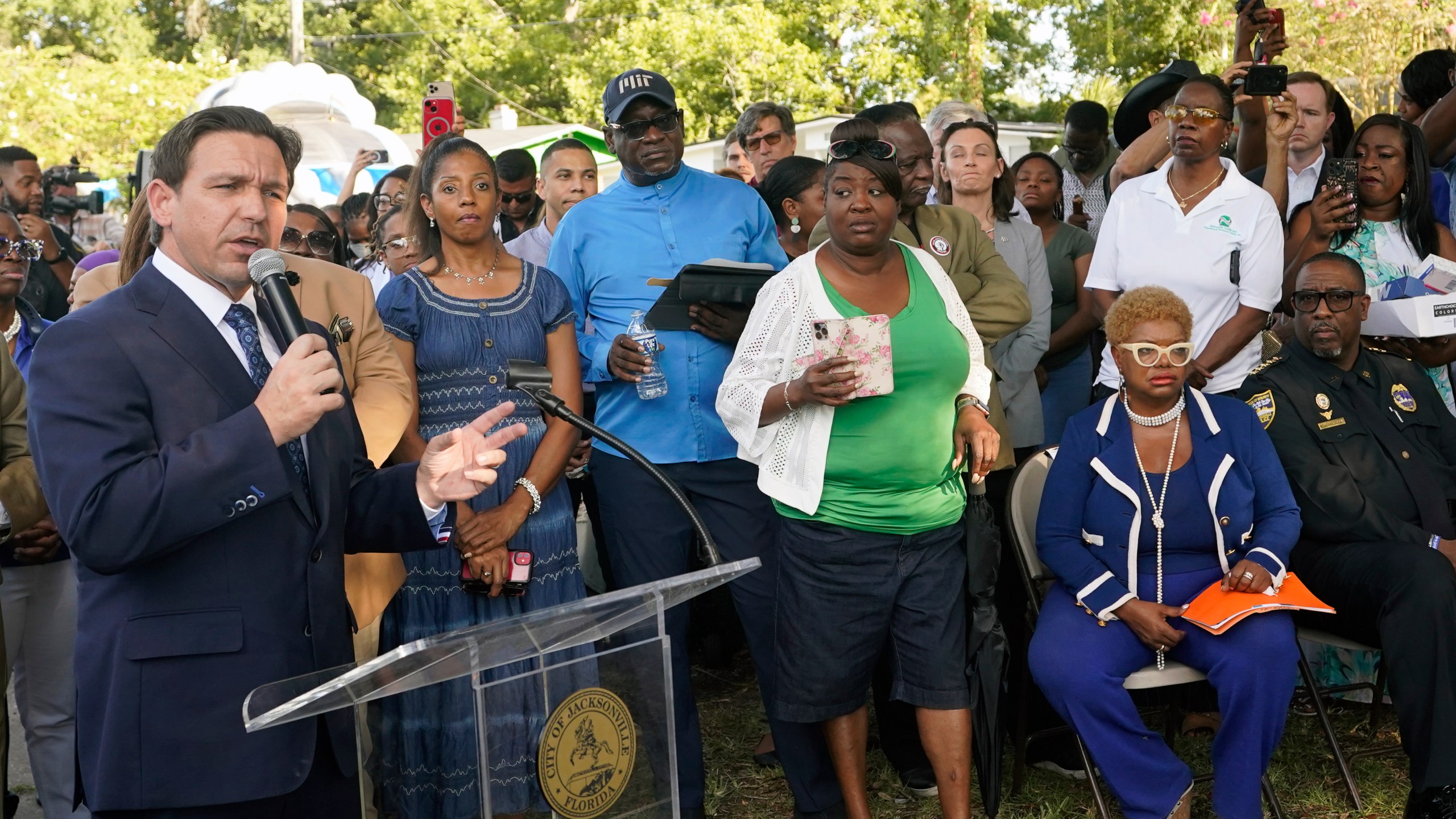 Florida Gov. Ron DeSantis, left, speaks at a prayer vigil for the victims of a mass shooting a day earlier, in Jacksonville, Fla., Sunday, Aug. 27, 2023. (AP Photo/John Raoux)