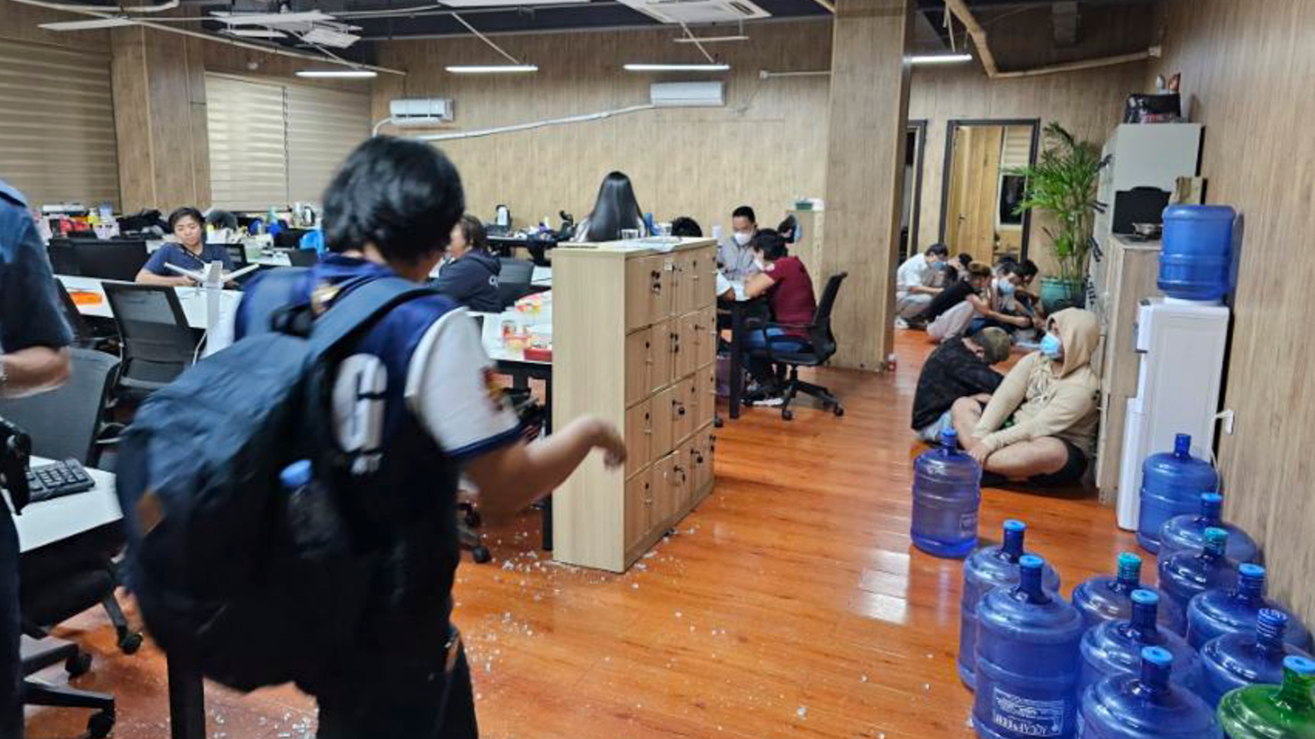 FILE - In this photo provided by the Philippine National Police Anti-Cybercrime Group, police walks inside one of the offices they raided in Las Pinas, Philippines, on June 27, 2023. The U.N. human rights office says criminal gangs have forced hundreds of thousands of people in Southeast Asia into participating in unlawful online scam operations, including false romantic ploys, bogus investment pitches, and illegal gambling schemes. (Philippine National Police Anti-Cybercrime Group via AP, File)